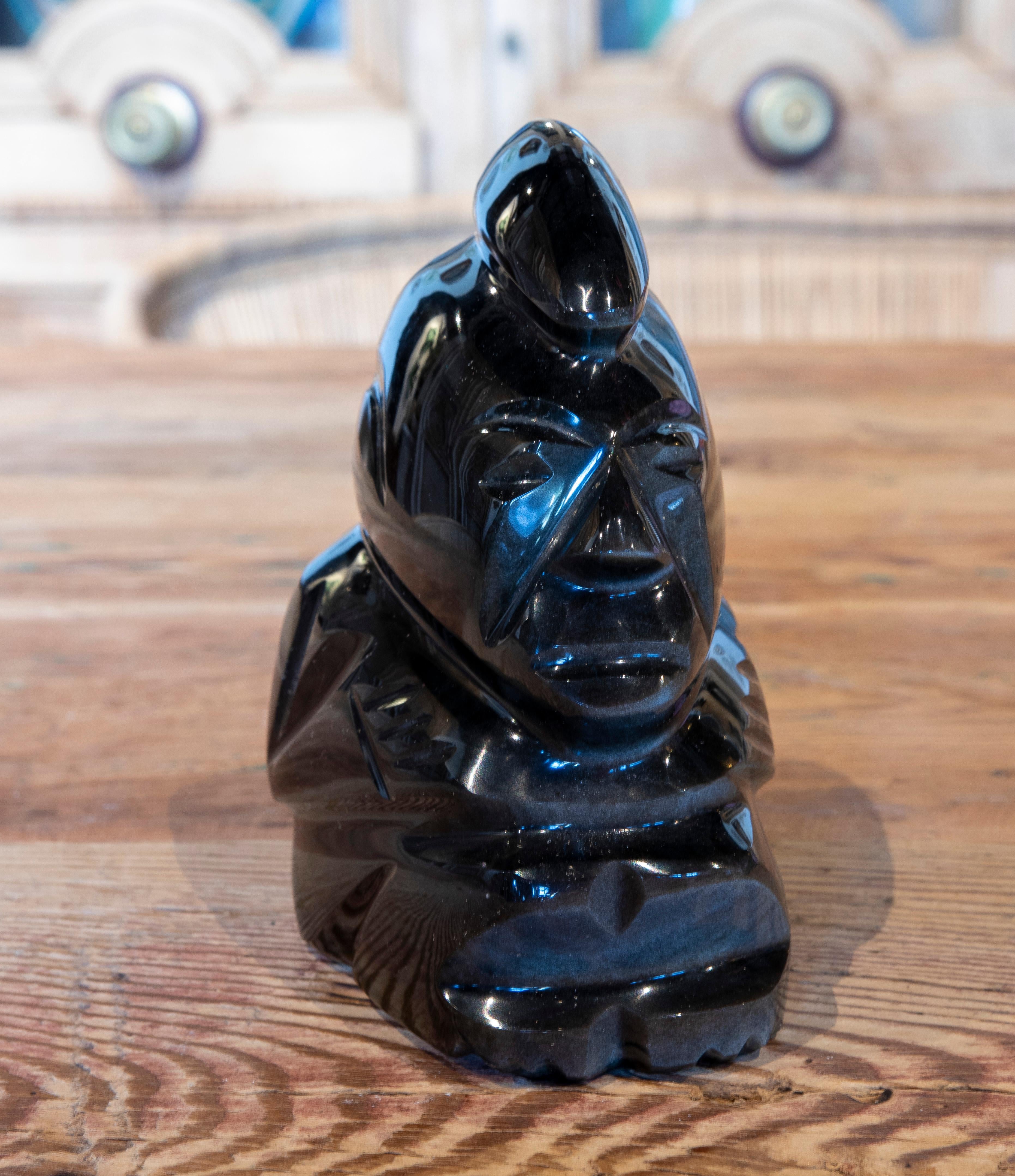 Hand carved glass figure of a semi-seated personage.