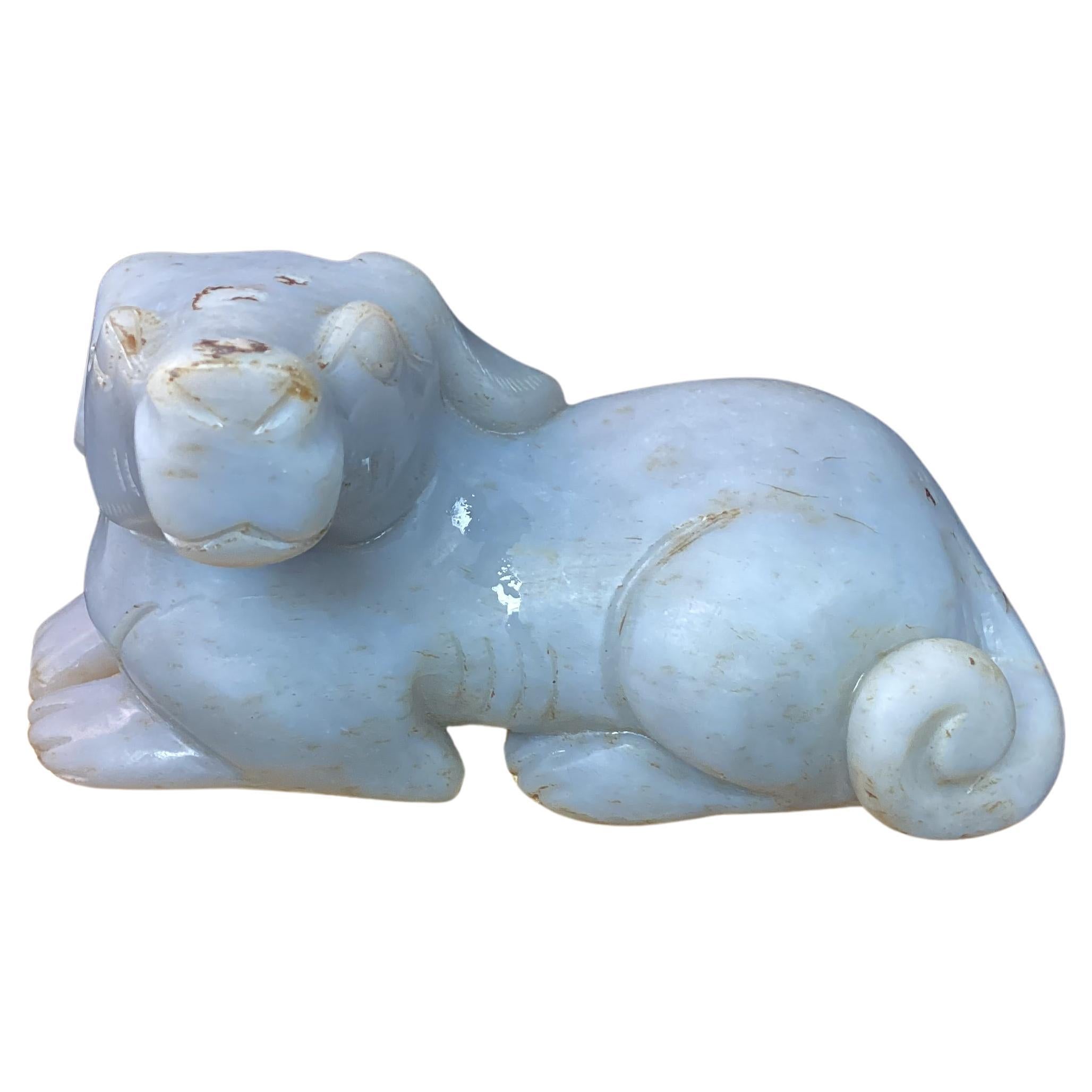 19th century figure of gray Chinese jade dog. Dog is lying down with tail curled around his body. Very intricately carved.