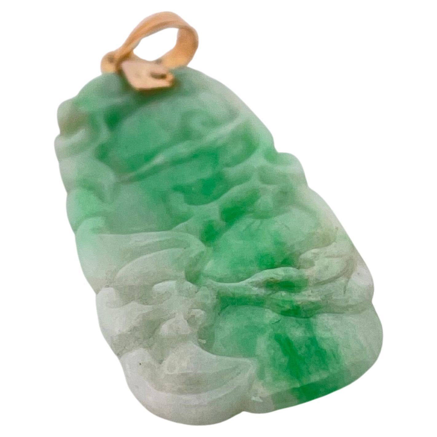 This exquisite pendant showcases the timeless elegance of hand-carved green jade, celebrated for its natural beauty and symbolic significance. Expertly sculpted with intricate detailing, the jade exhibits a captivating gradient of lush green tones