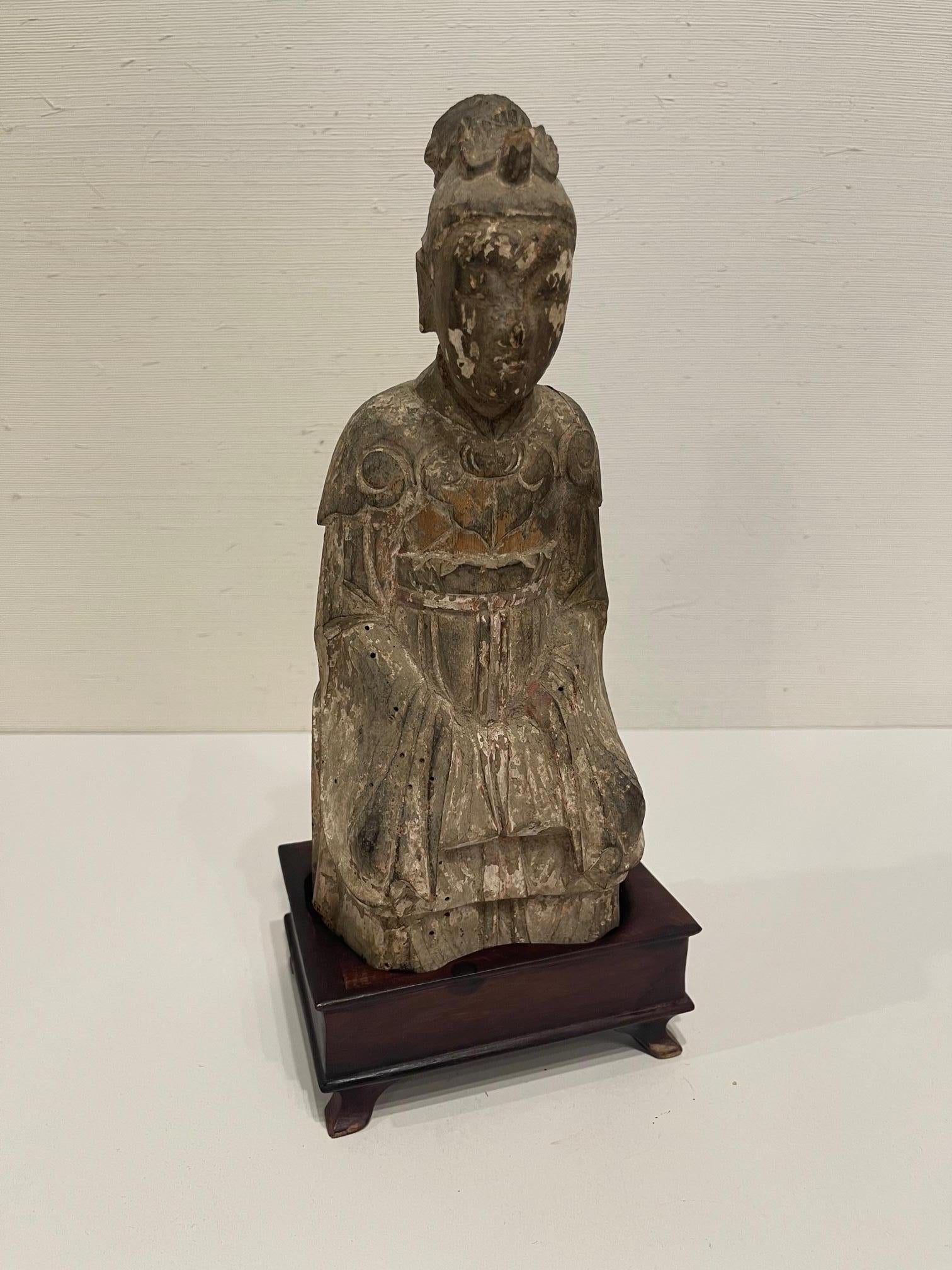 Hand carved Guanyin Chinese Goddess of Mercy on wood stand from the Florida Museum Elizabeth, Austin, 19th century.
  