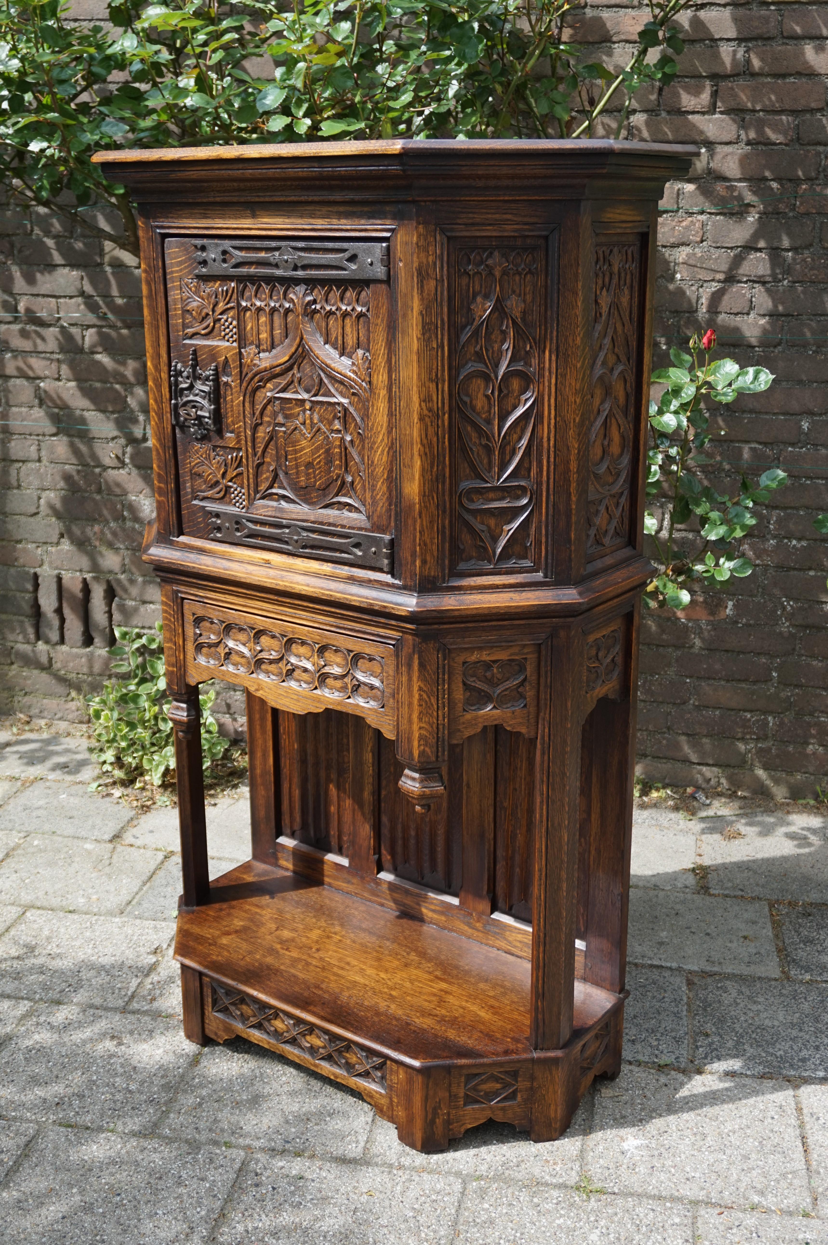 Stunning, early 20th century handcrafted Gothic sideboard.

This beautifully handcrafted Gothic cabinet is made with the exact same Gothic motifs and with the exact same techniques and materials as it would have been in Mediëval times which makes it