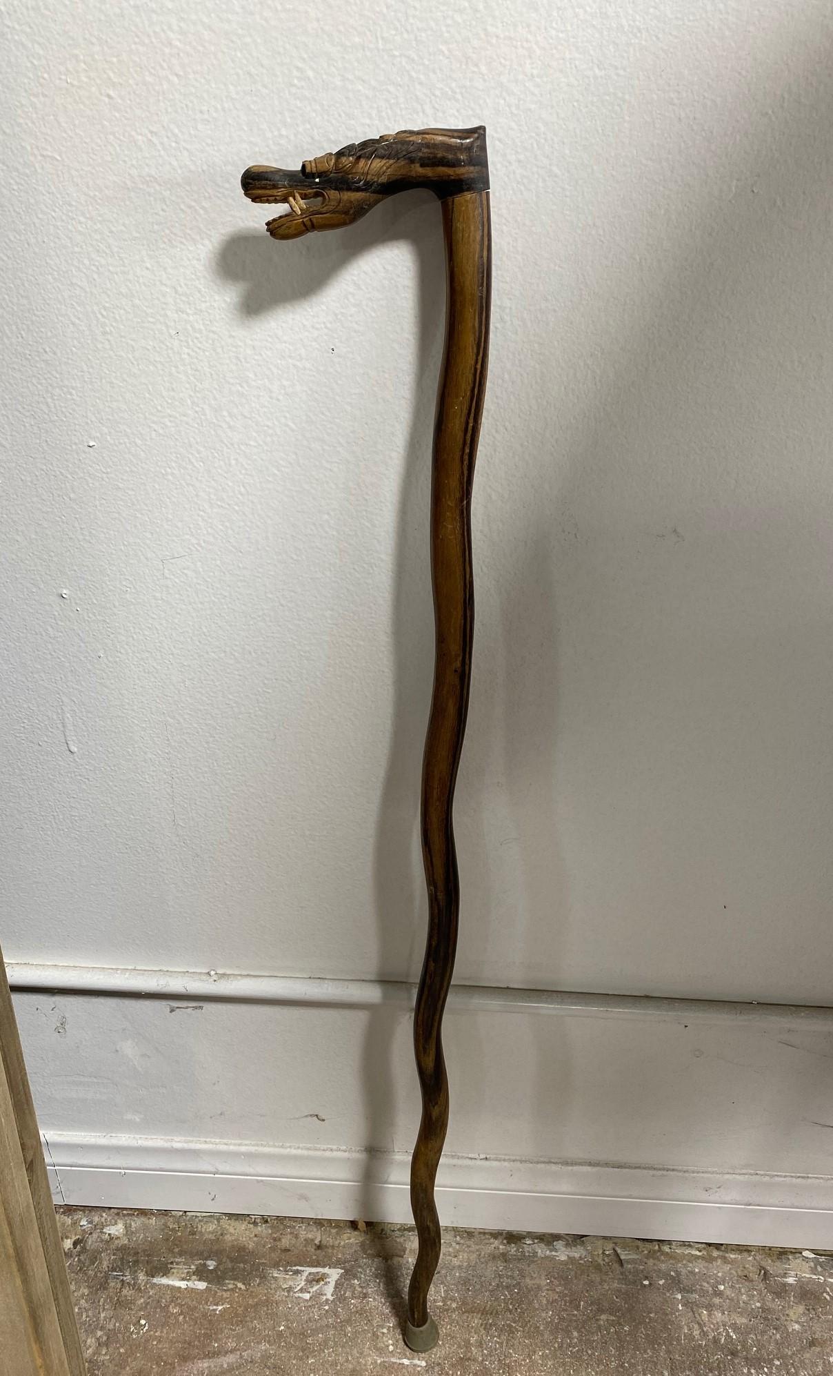 A rather fantastic and unusual walking stick/ cane. Hand-carved from hardwood. 

Has a great feel to it.

A unique piece to add to your collection.

Dimensions: 36.5