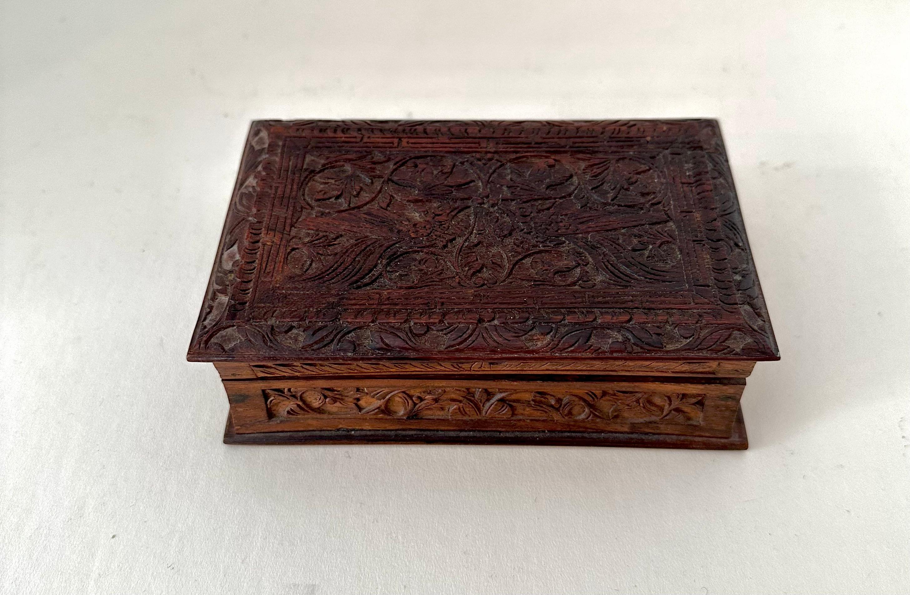 A simple hinged wooden box with carving. The box would be ideal for 420, notes, recipes, or on the desk to hold paper clips, rubber bands, etc. or on the nightstand. 

A beautiful box with a lot of character.