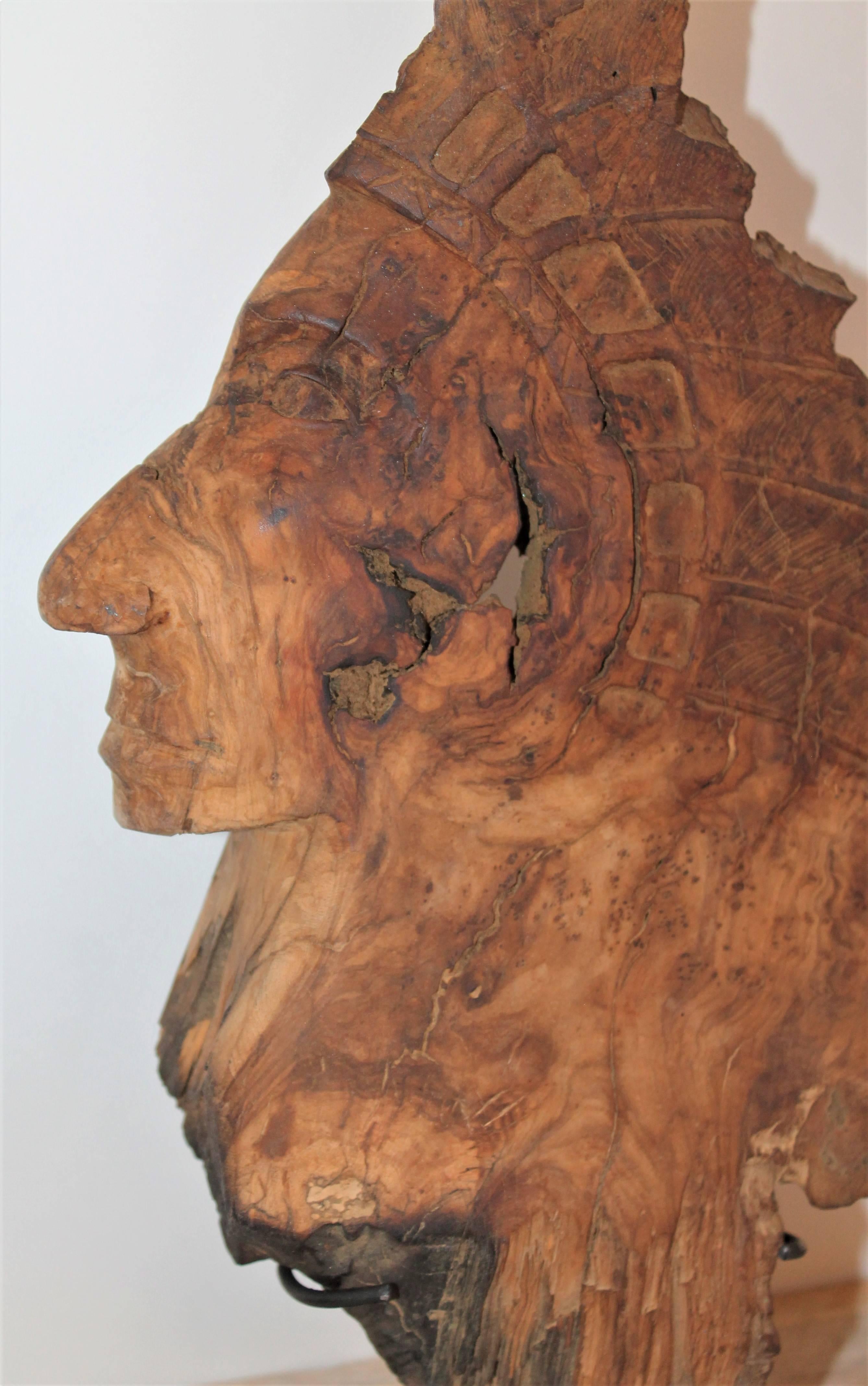 This is a hand-carved Indian head is carved from one piece of burl wood and is on a cast iron mount. The condition is very good.