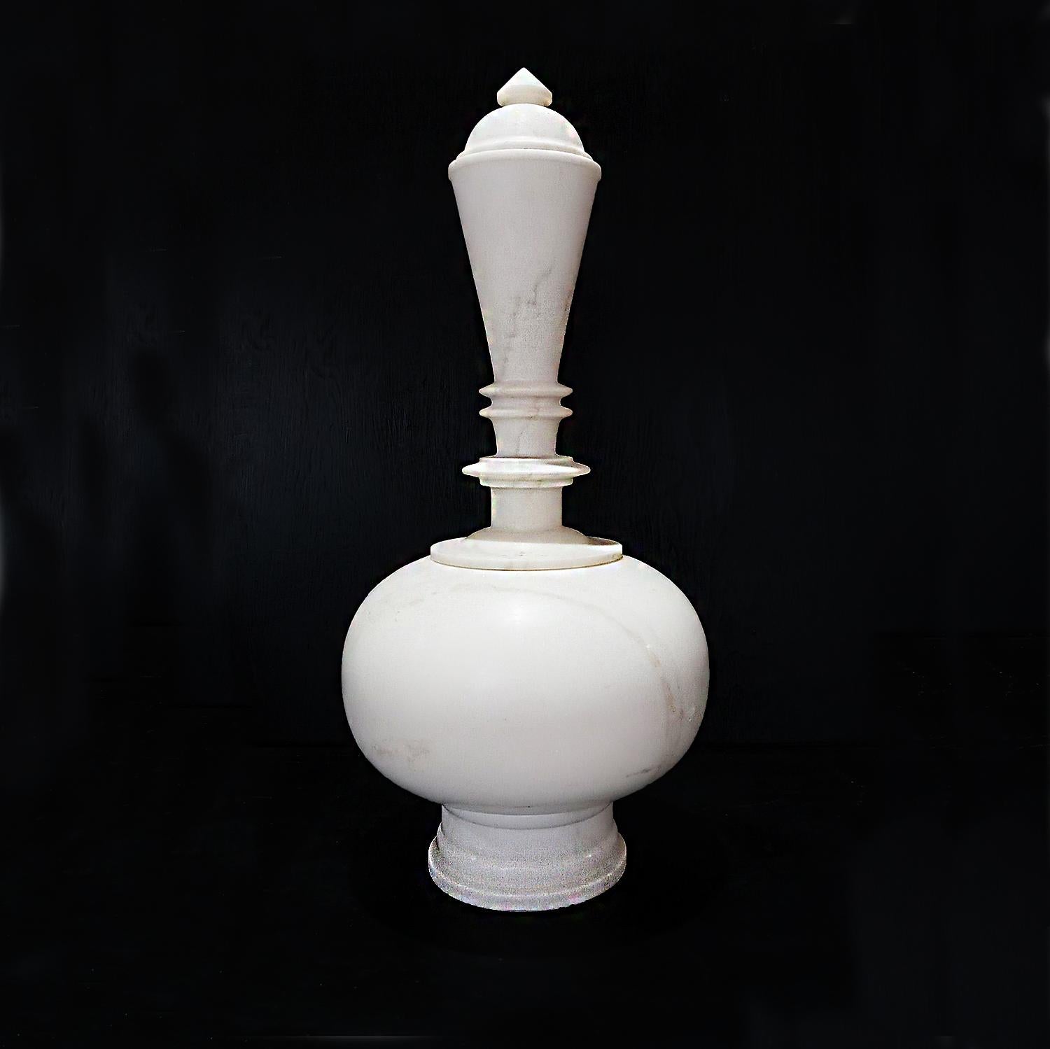 A superb fluted neck vase with lid, hand carved in India out of smooth white marble and polished to perfection. Top and bottom are detached into two pieces, which makes the round bottom part of the vase useful for flower arrangements. A marble cap