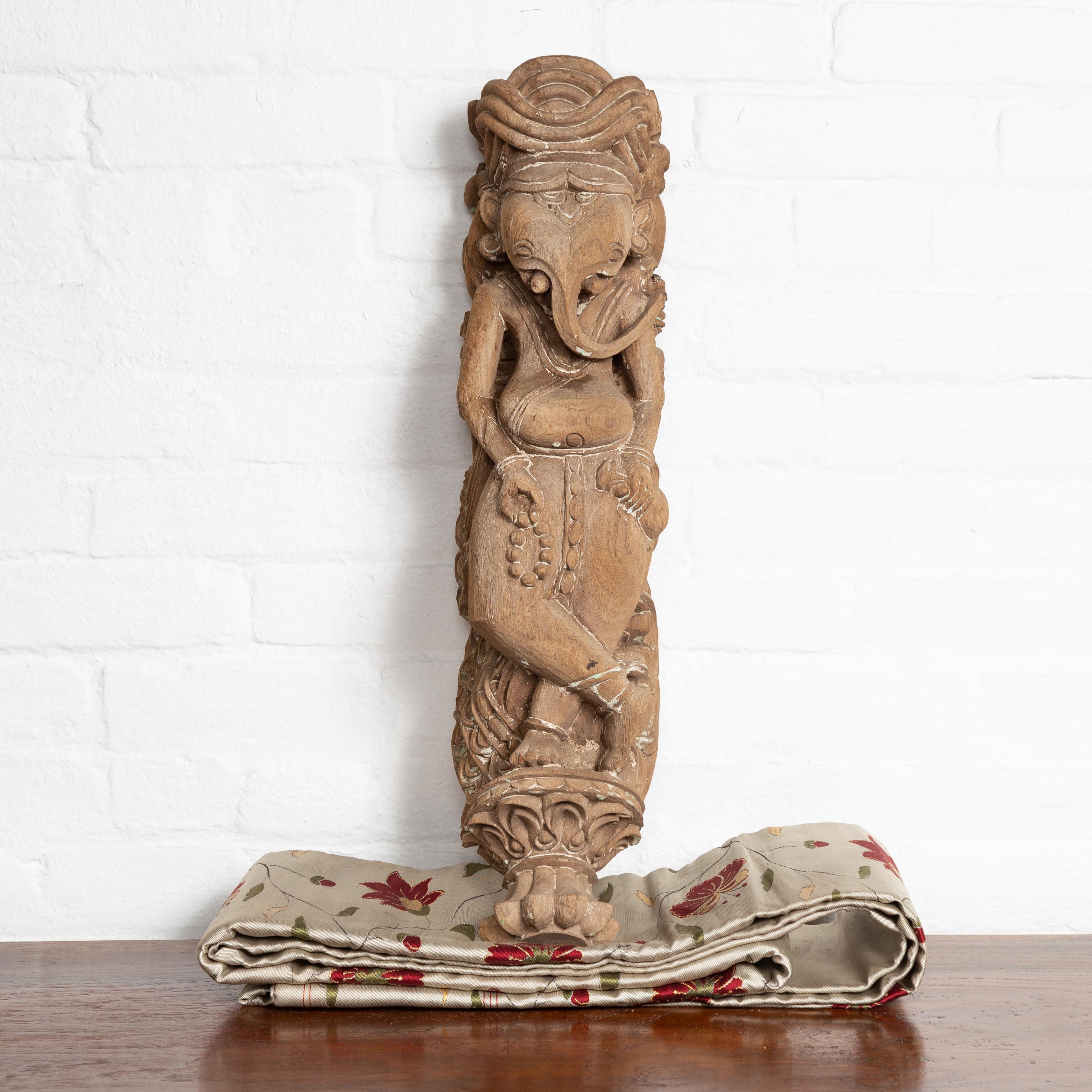 An early 20th century Indian architectural temple sculpture from Gujarat, depicting the Hindu deity Ganesha. Born in the Western portion of India in the state of Gujarat, this exquisite hand carved temple sculpture features the Hindu god Ganesha,