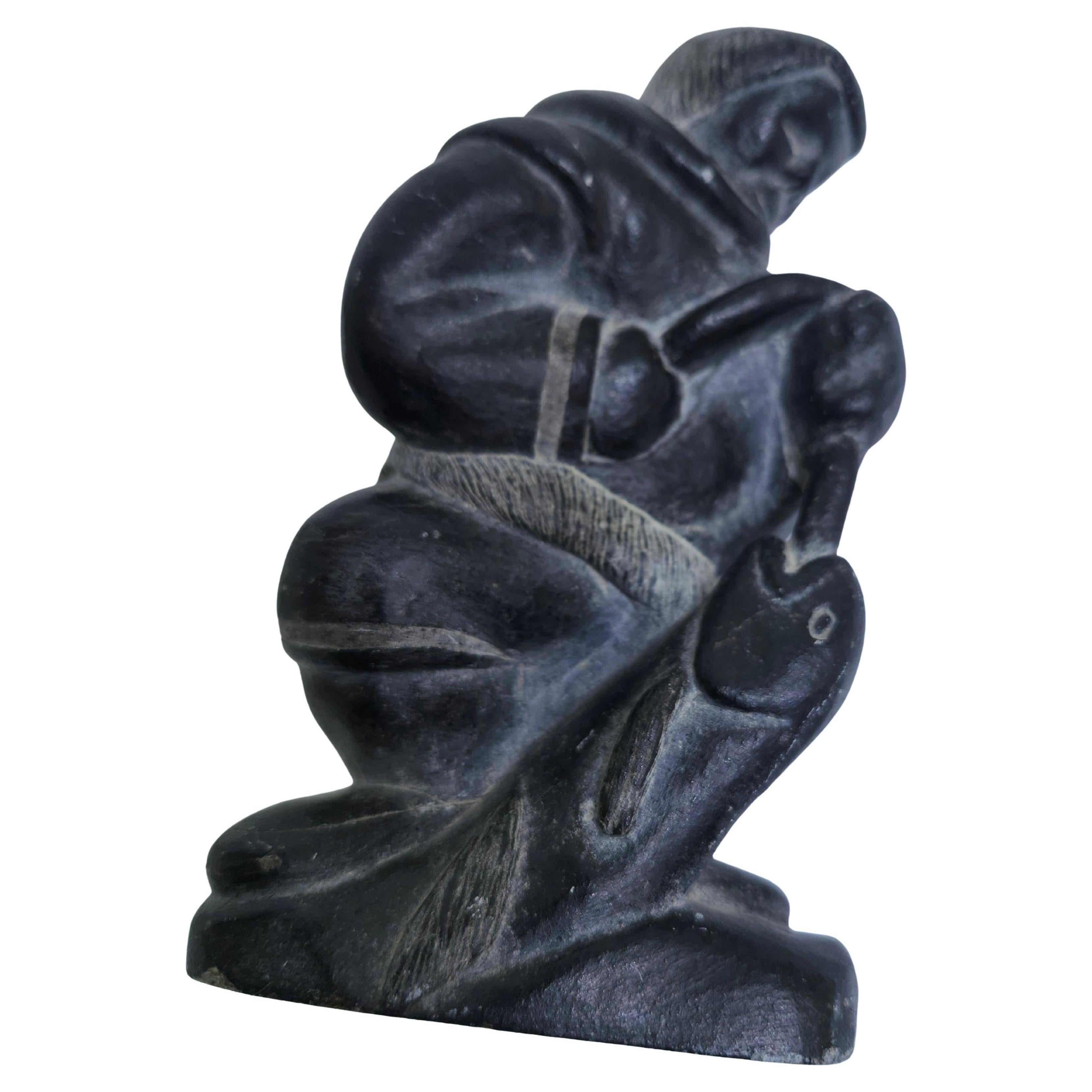 Hand carved Inuit figure of a man with fish in Soapstone. Intricate carving detailed and in excellent vintage condition with minimal wear. Signed on the underside. Either from Alaska or Canada C1975.
Please see all pics and video as that is part of