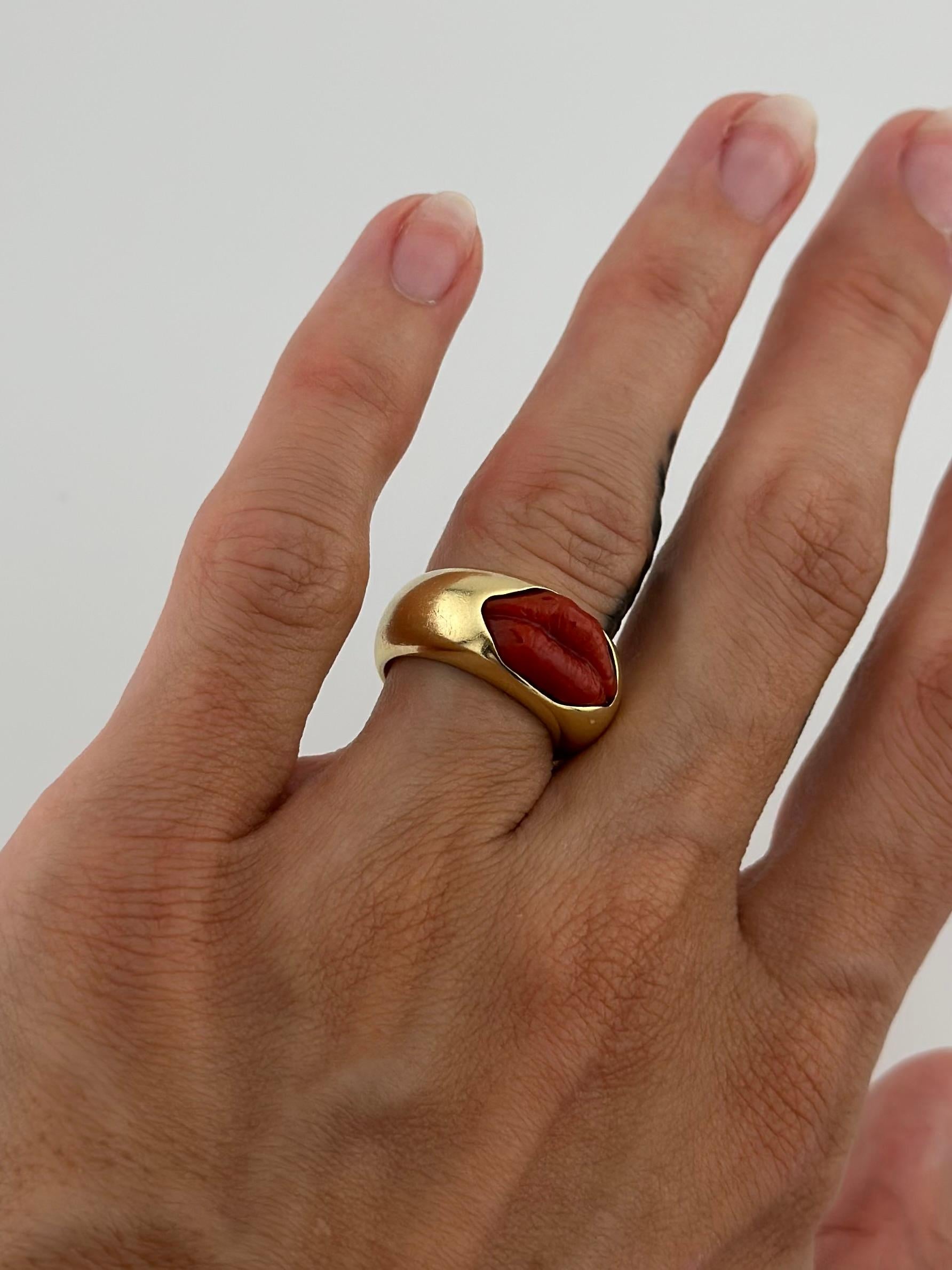 Rare hand carved, natural blood coral lips, crafted and sourced in Naples, Italy. Set in a 18k yellow gold dome ring, handmade in Los Angeles by designer Grunfeld. Size 5 US, but can be sized if needed free of charge. The total weight is 14 grams.