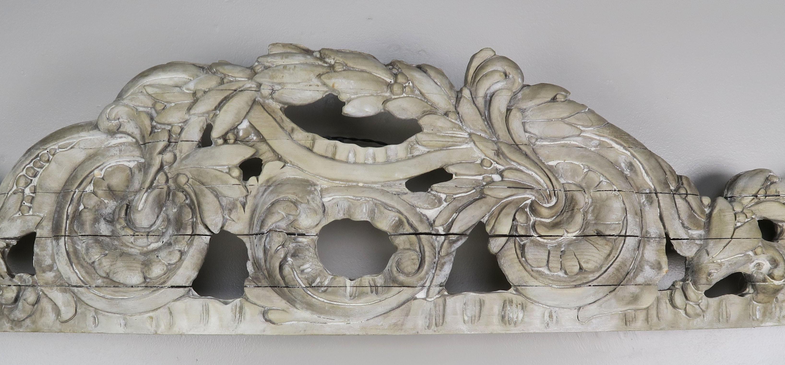 Italian wood carving that has a slight arch which would make it a perfect bed canopy with fabric draping down underneath or on its own over a door or window. Natural wood finish with tiny remnants of paint.