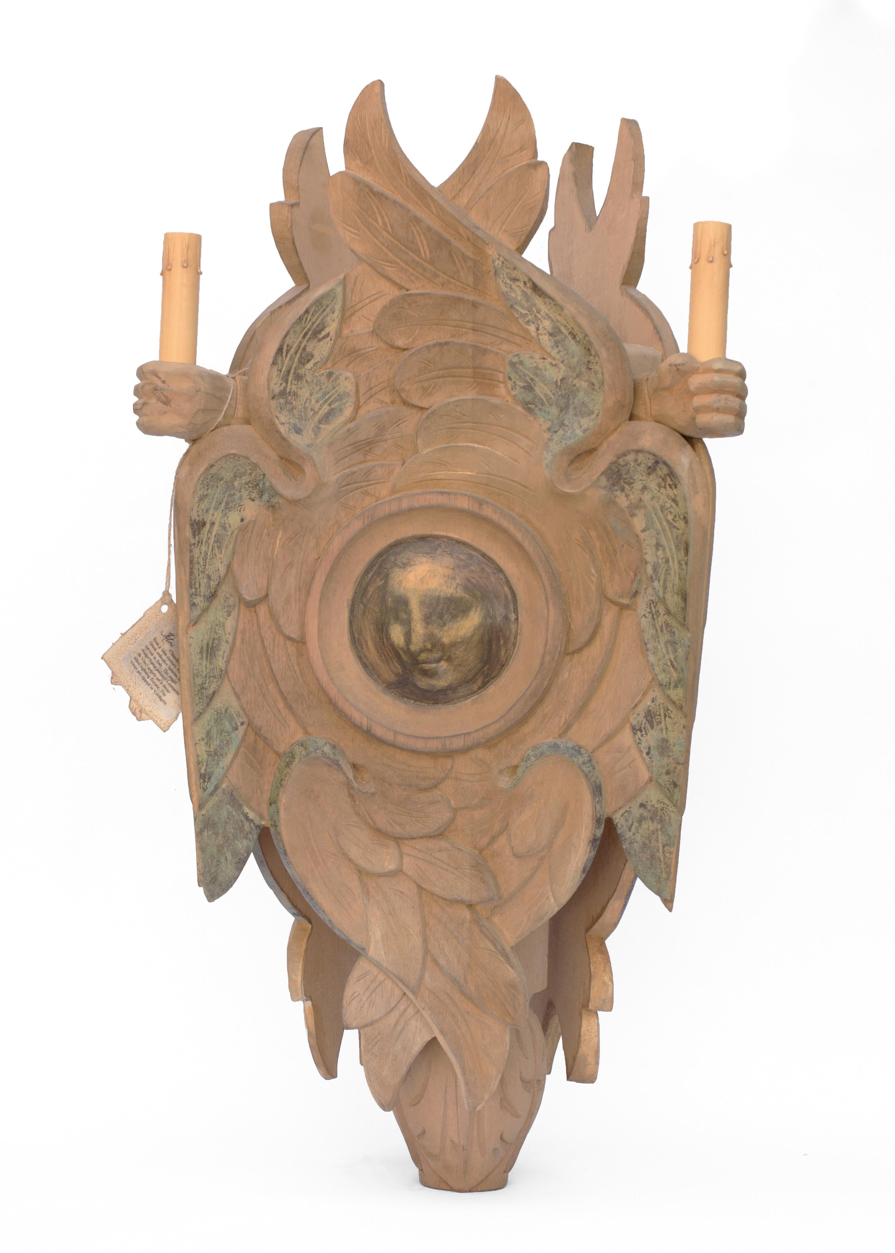 Hand-carved Italian painted wood lantern. This chandelier lantern inspired from a 16th century Russian Greek orthodox lantern. The angel faces attributed to Leonardo da Vinci and are on the three-sided lighting fixture with angel wings framing them.