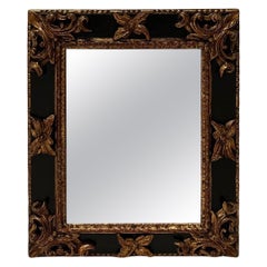 Miroir italien de style rococo sculpté à la main, ébénisé et or ancien