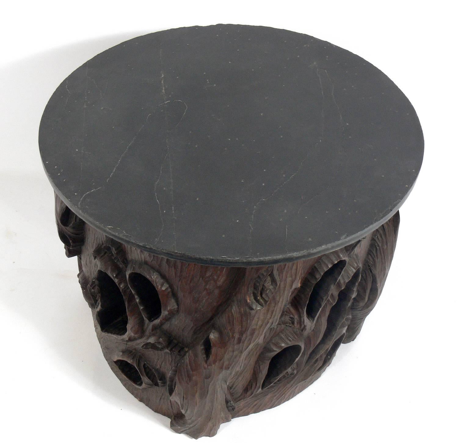 Hand-carved Japanese stump table with slate top, believed to be circa 1950s, possibly earlier. This table has an incredible hand-carved base, made out of one solid tree stump and is surmounted with a slate top. It is a versatile size and can be used