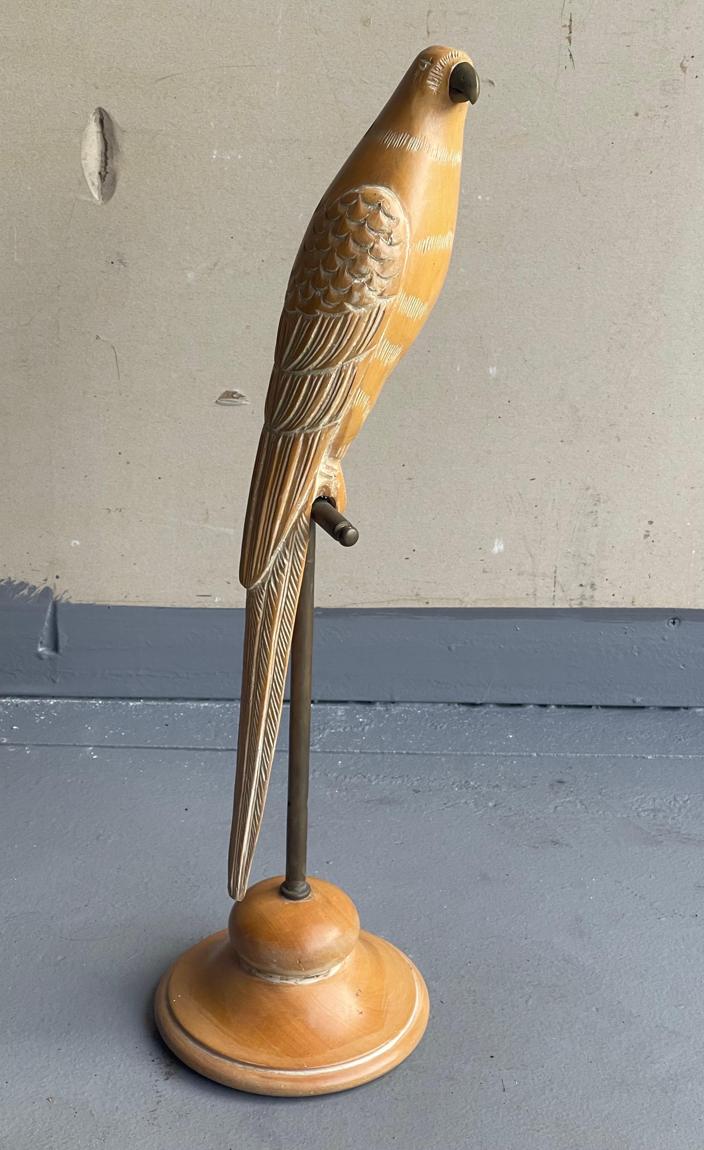 A very cool hand carved knotty pine wood parrot on perch sculpture by Sarreid Ltd., circa 1970s. The sculpture has a white wash overlay finish and sits on a brass rod; the piece is in very good condition and was made in Spain. It measures 6.25