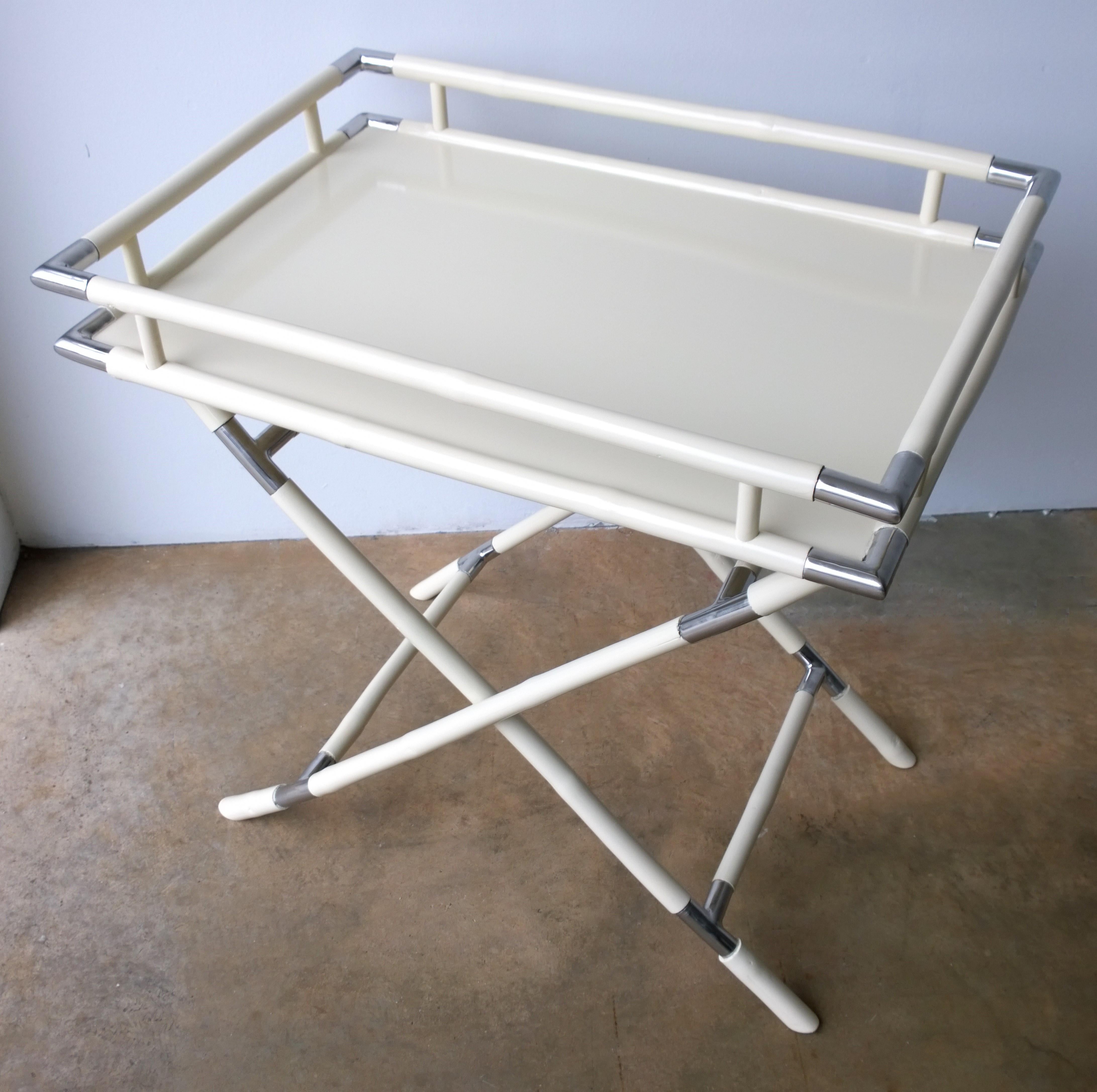 Offered is a Mid-Century Modern Albrizzi style two-piece tray and folding stand newly lacquered in a creamy white / off-white hand carved bamboo wood with chrome accents. The creamy white newly lacquered tray with Classic modern lines and folding