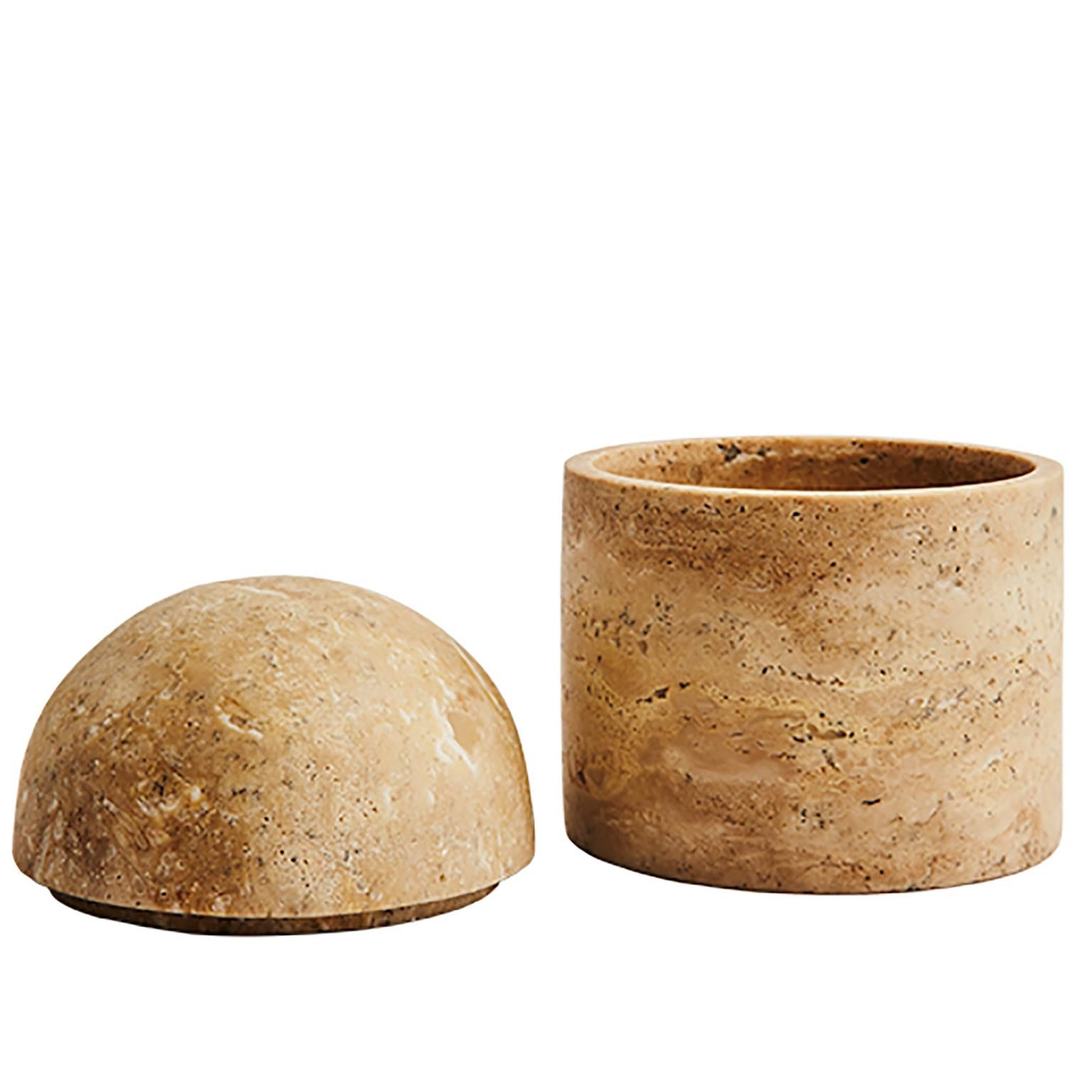 These playful beehive-inspired domes are beautiful decorative pieces that also conceal your most prized possessions. This family of vessels are hand carved and offered in two sizes. The texture and warmth of the travertine stone plays well with the