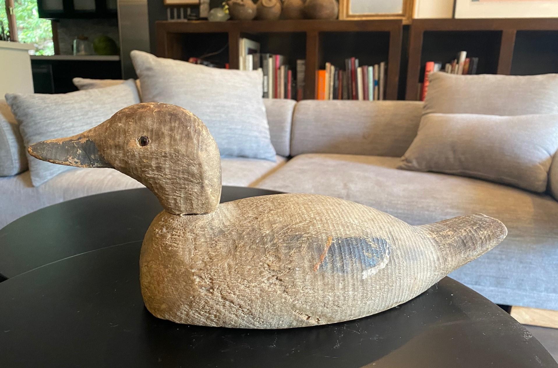 A fantastic early to Mid-20th Century hand-carved and painted wood duck or mallard decoy with glass eyes.  This piece has an wonderful color and texture.  

From an impressive Los Angeles vintage duck and antique swan decoy collection.  

Marked