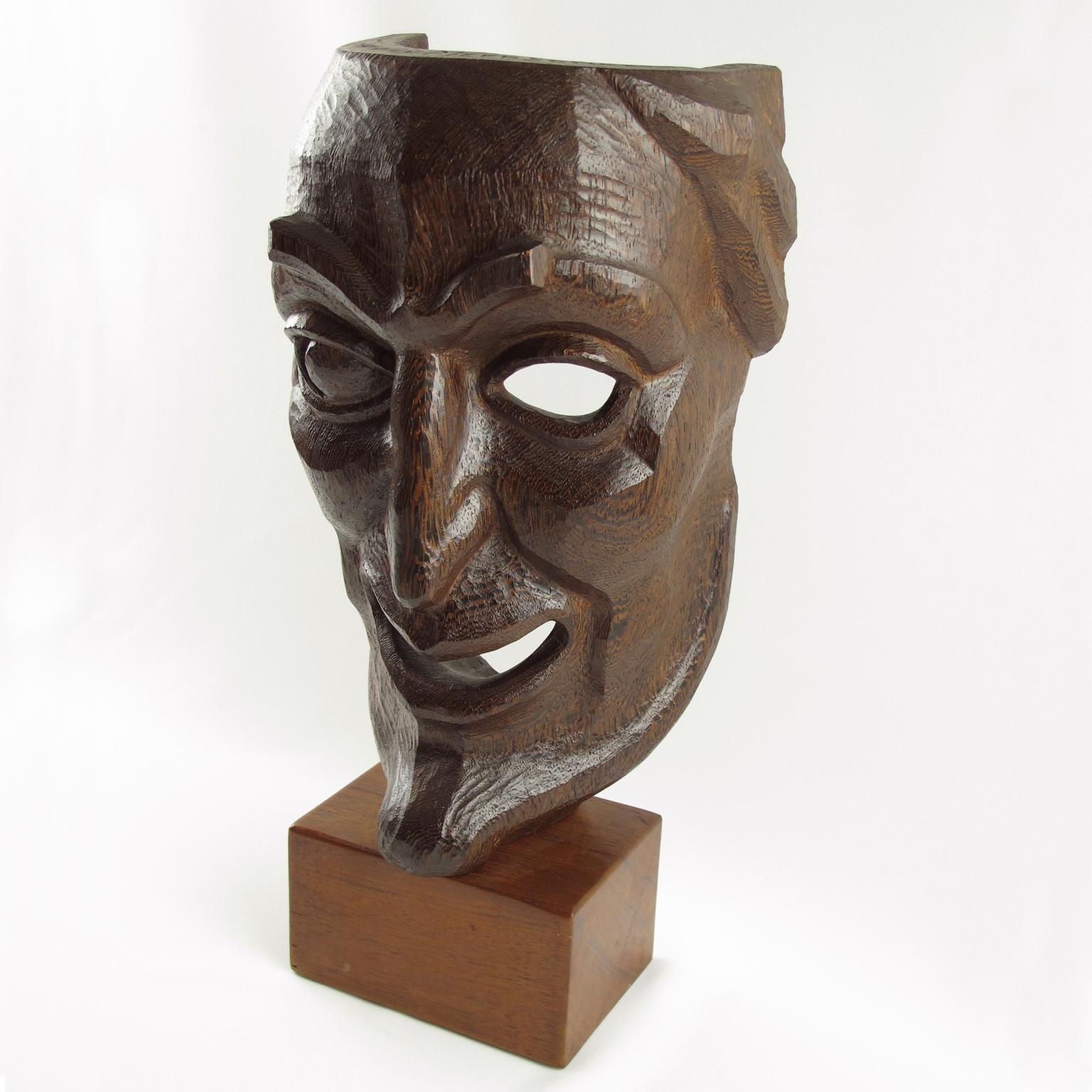 Stunning mid-20th Century hand-carved wood mask sculpture. Palmwood with a beautiful carving with fine detailing and texture, featuring a caricature character in the style of La Comedia Dell'Arte in Italy, but also the classical masks from the