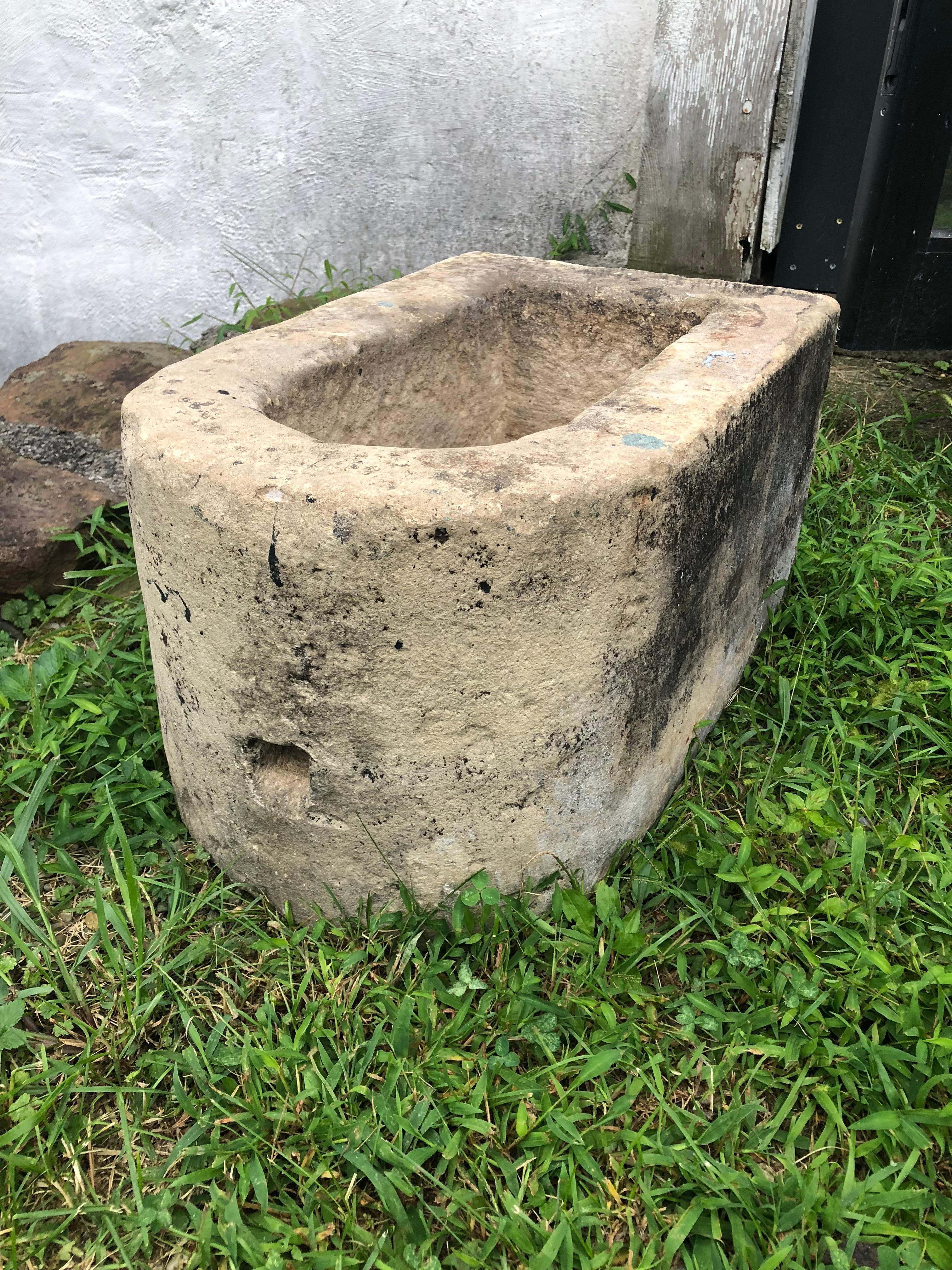 A French 18th century limestone basin with drain hole, possibly from a downspout. Hand carved with nice patina.