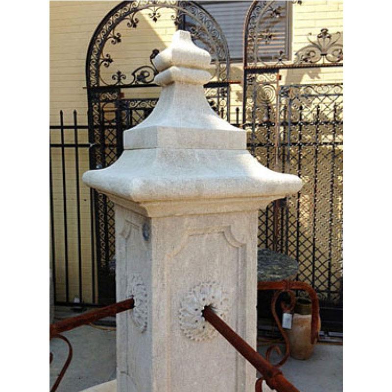 Here we offer a custom hand carved limestone central fountain with four down spouts. This fountain was designed after an antique village fountain recovered by our partners in France, but the size was adjusted to meet a clients needs. The ability to