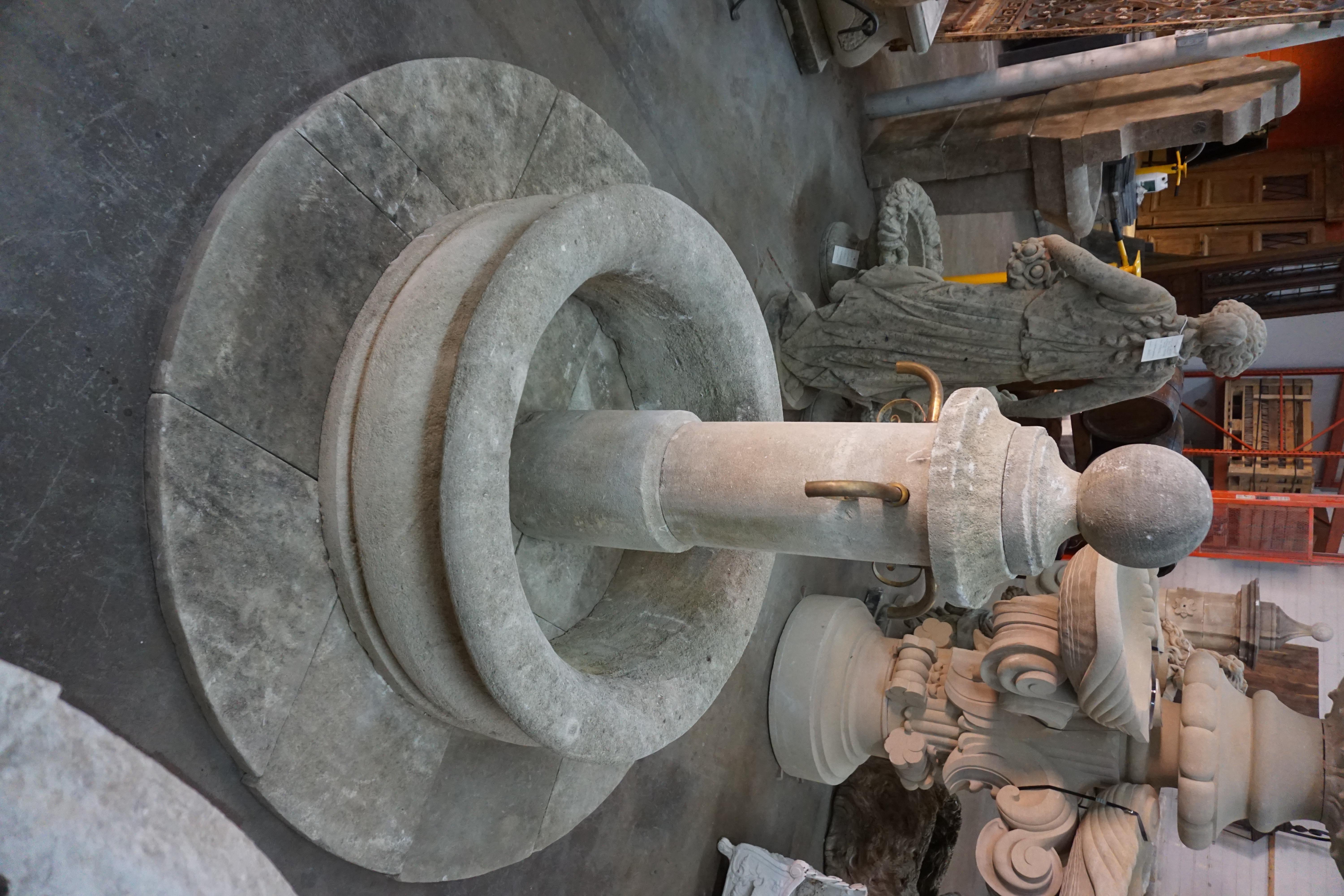 Here we offer a hand carved limestone central fountain with three iron downspouts. This fountain includes a limestone deck to separate the wall from ground level and a basin wall that has been carved from a single boulder of limestone that gives the