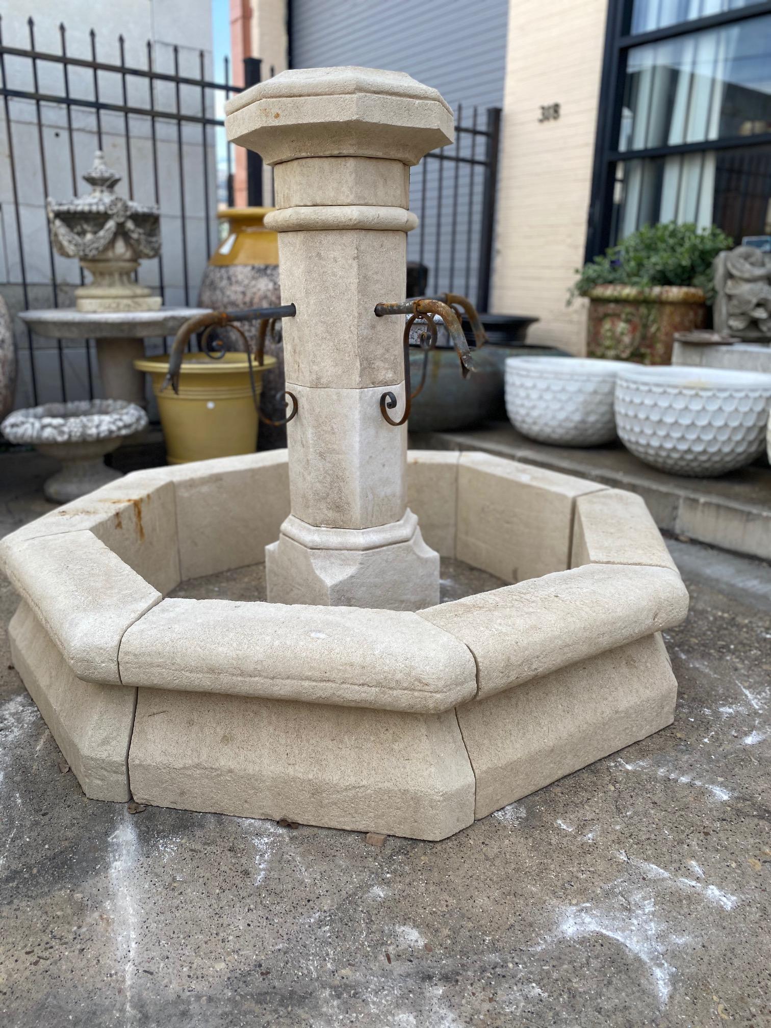 Here we offer a hand carved limestone central fountain with four iron down spouts. This piece stands tall and can be admired from a distance as part of the landscape design or be the focal point of your courtyard or garden as it fills the air with