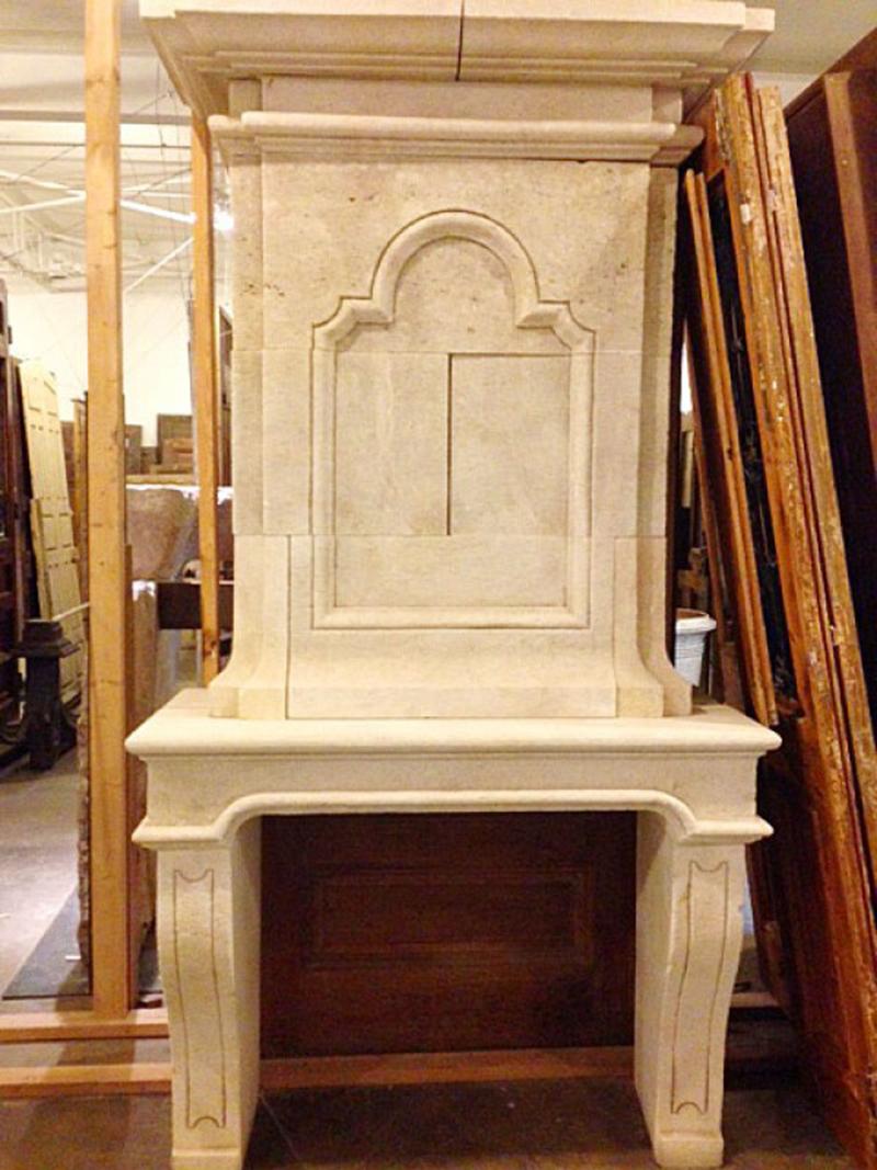 Hand carved from white limestone, this mantel has a scroll-like design at the top of the panel and architectural line along the legs and lentil.

Measurements: 53 1/4