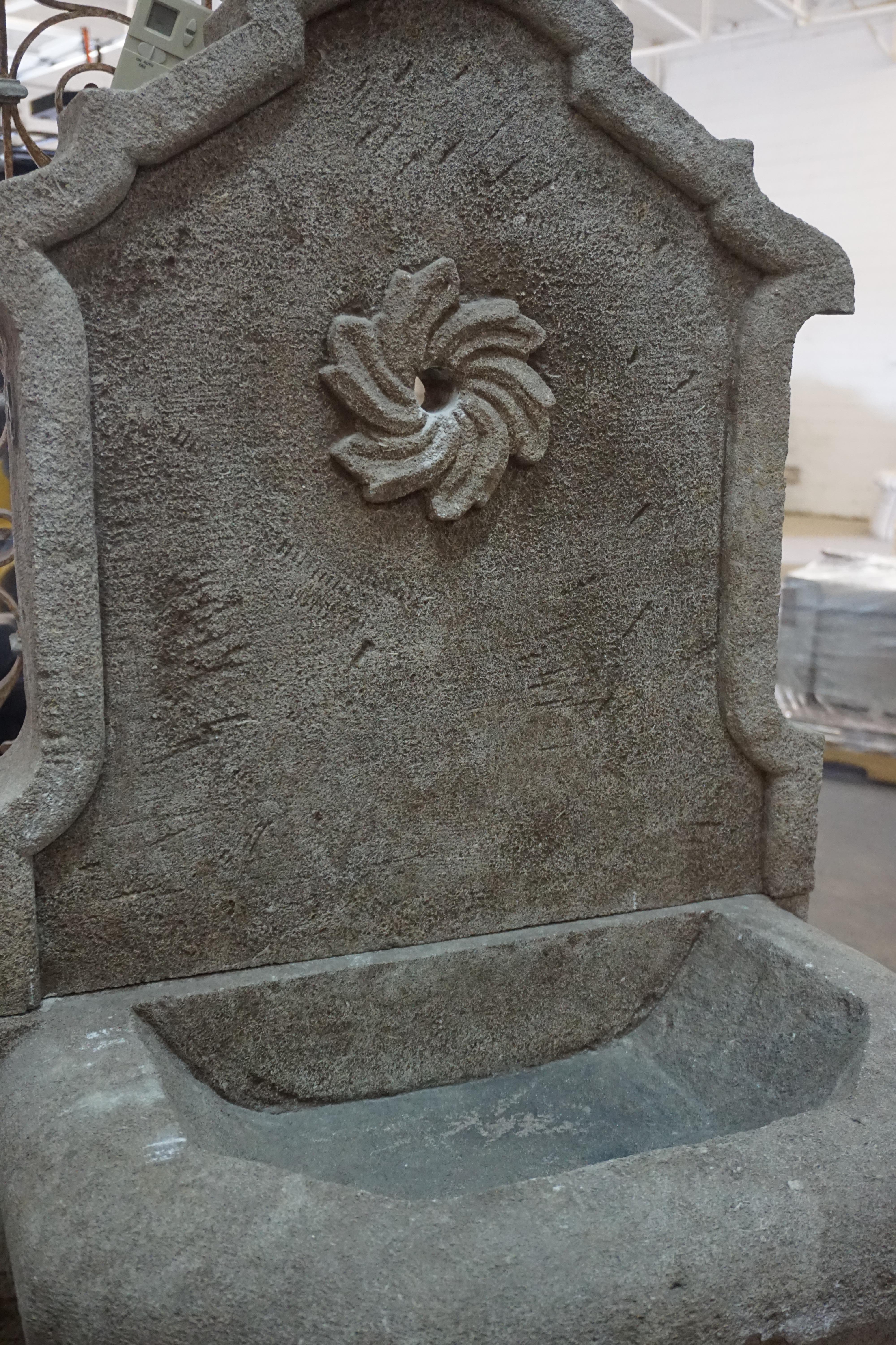 This hand carved wall fountain is made of limestone and features a floral motif surrounding the spout. Perfect for a quaint garden!

Measurements: 26