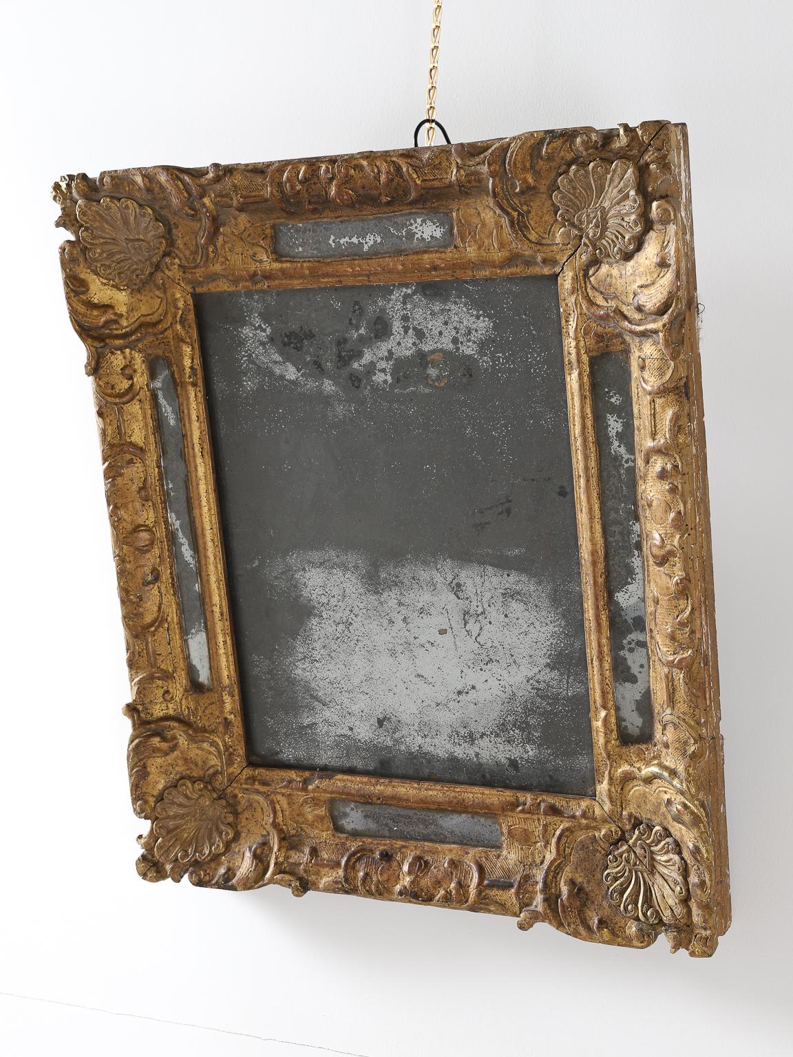 Elegant 17th century hand carved oak wall mirror. High-quality Louis XIV period framing with gold leaf gilding.