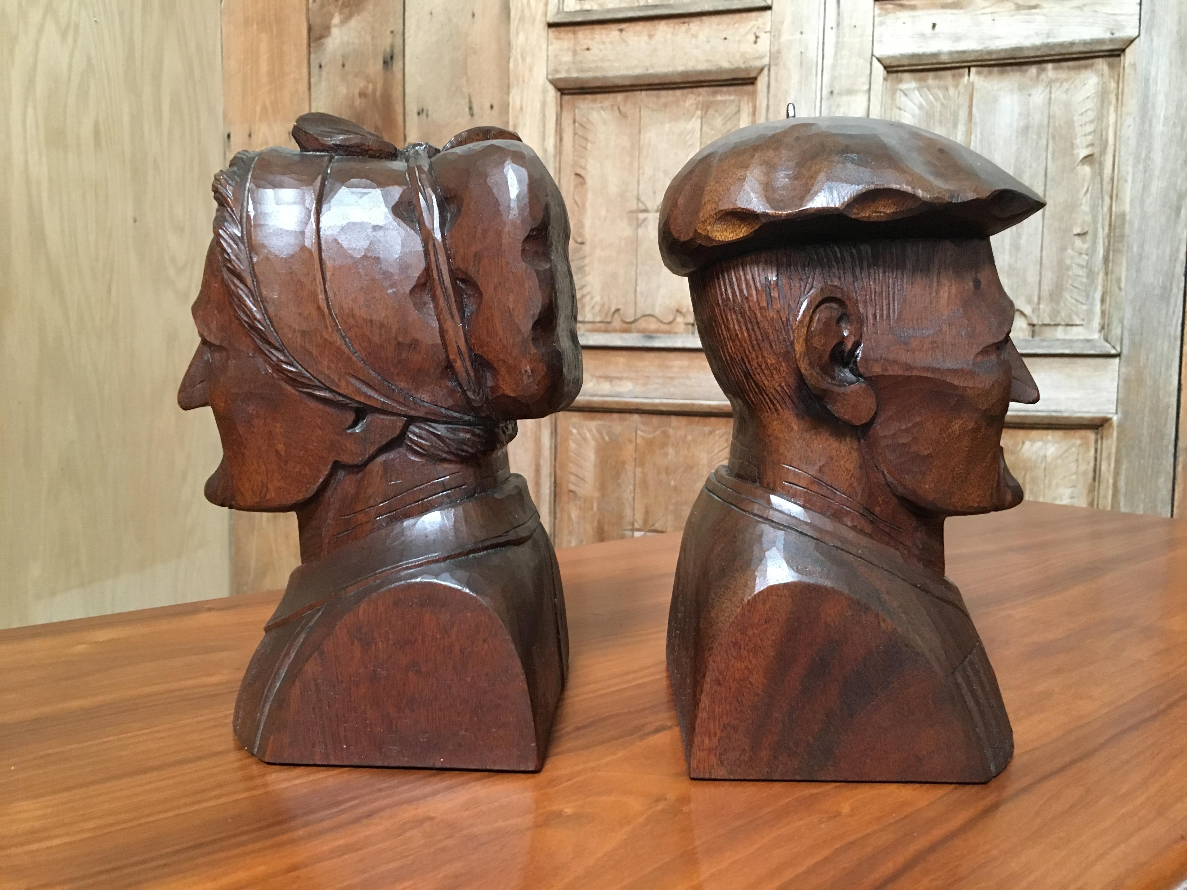 Solid hardwood carved antique sculptures of a French man and woman can be used as bookends or on their own.