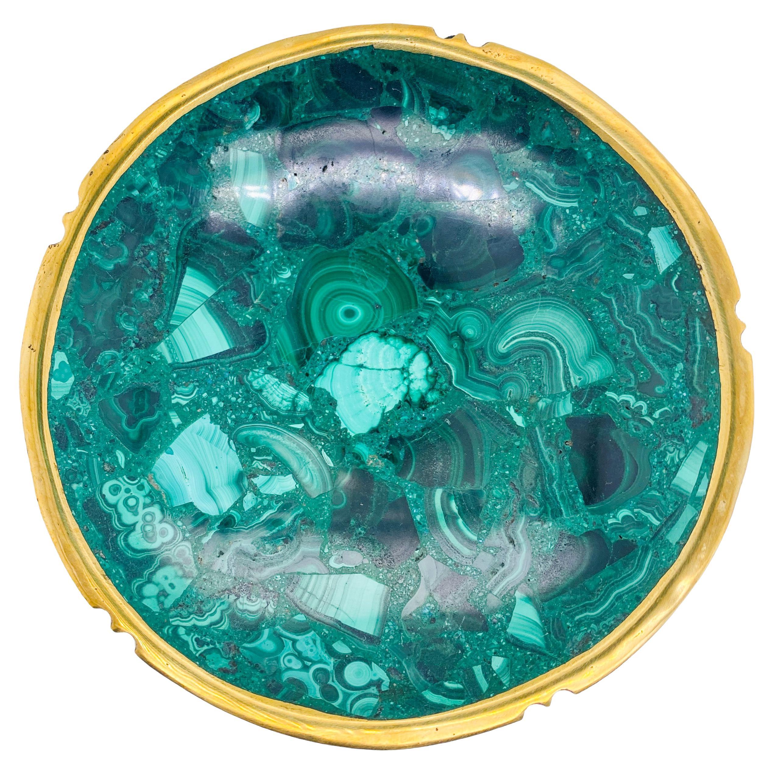 This gorgeous malachite dish is a magnificent velvety green statement piece. The bowl is created from beautiful malachite pieces that are pieced together and carved and polished to perfection. The round 4 inch malachite bowl sits 1 inch high. This