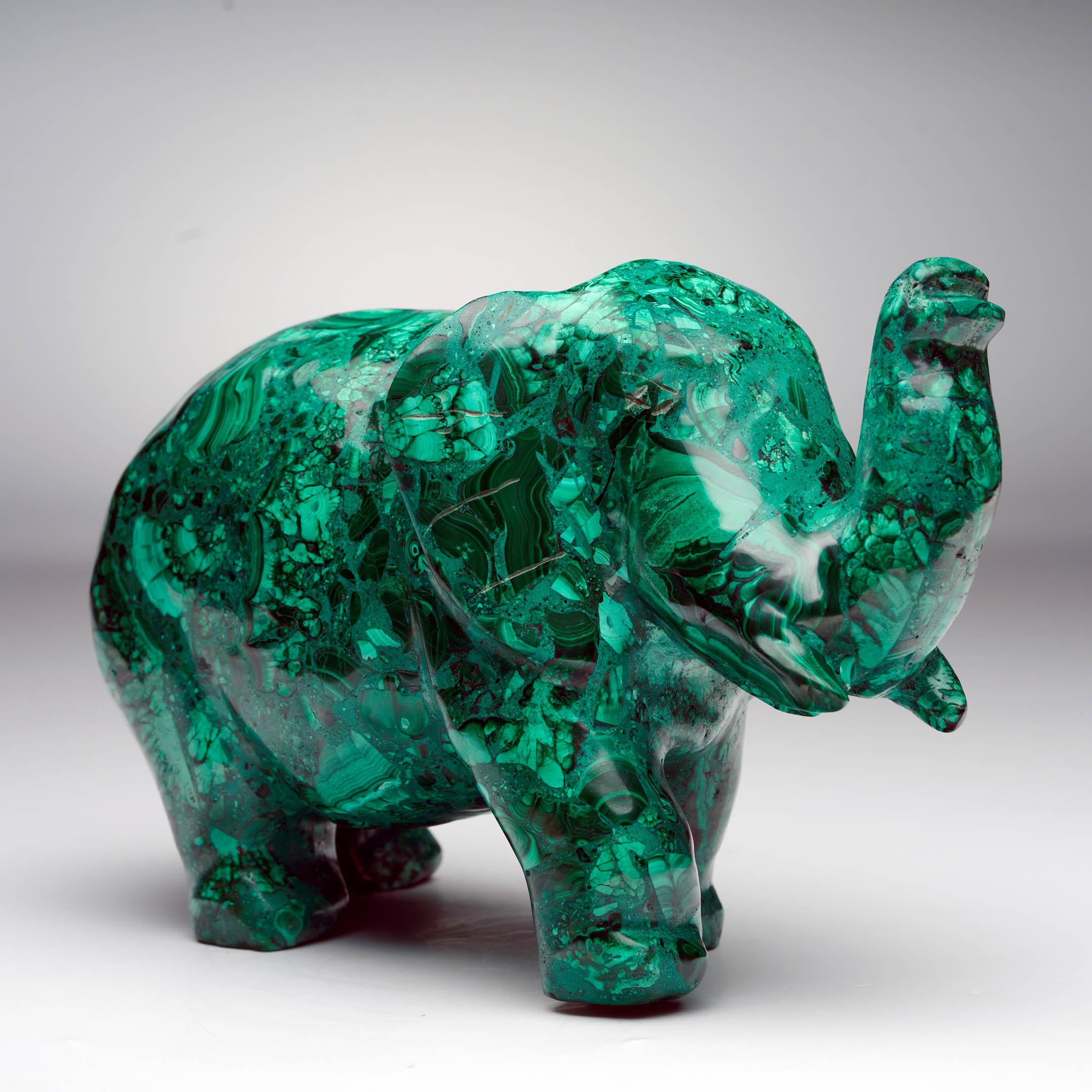 This hand-carved Malachite elephant showcases the stone’s vibrant green hues and complex banded patterns. Every angle reveals malachite's natural artistry: deep emerald tones flow into lighter shades, concentric formations or bullseyes ripple across