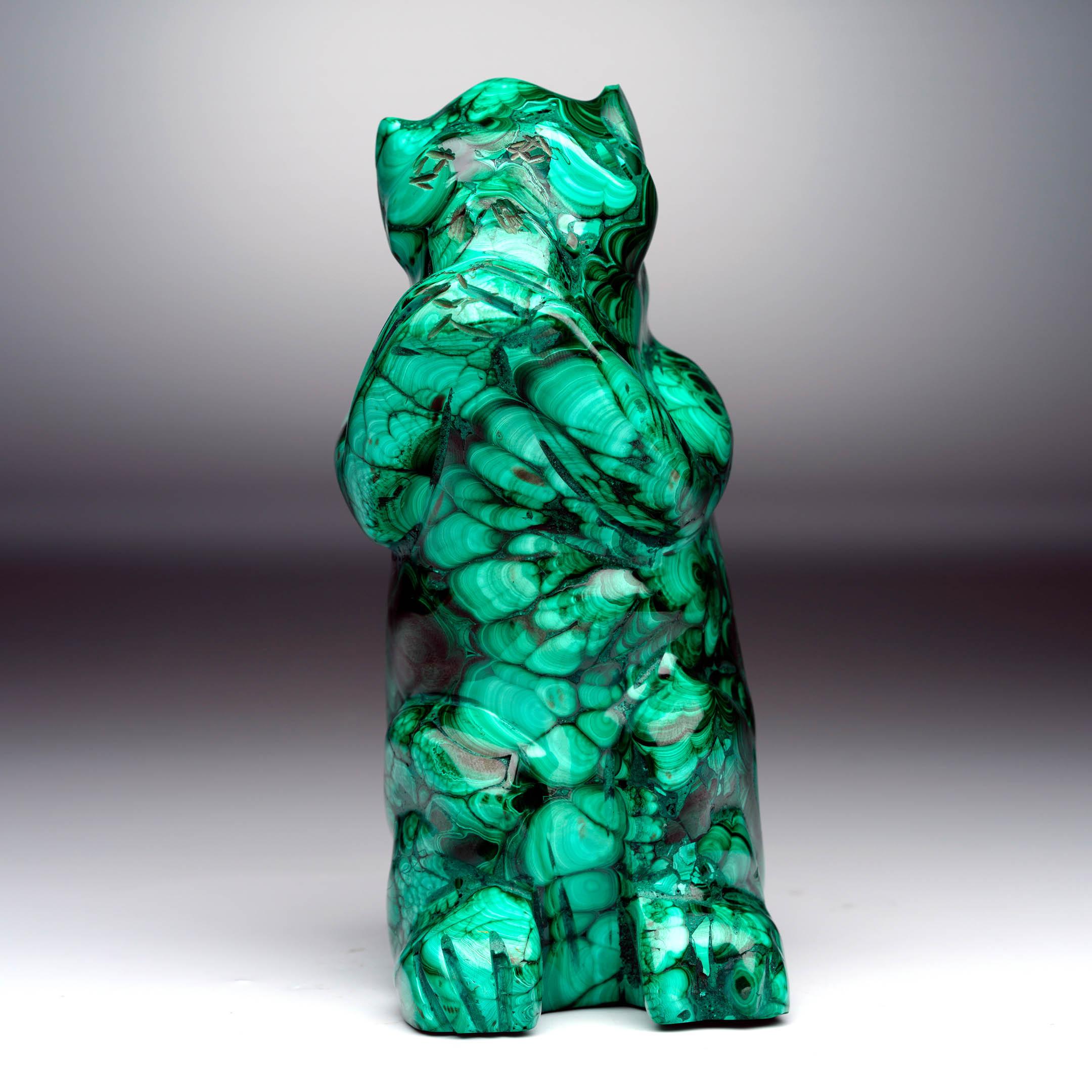 This hand-carved Malachite monkey sculpture combines natural mineral beauty with refined artistry, making it a captivating decorative accent. Carved from a single piece of genuine Malachite, the figure reveals the stone’s signature banding: