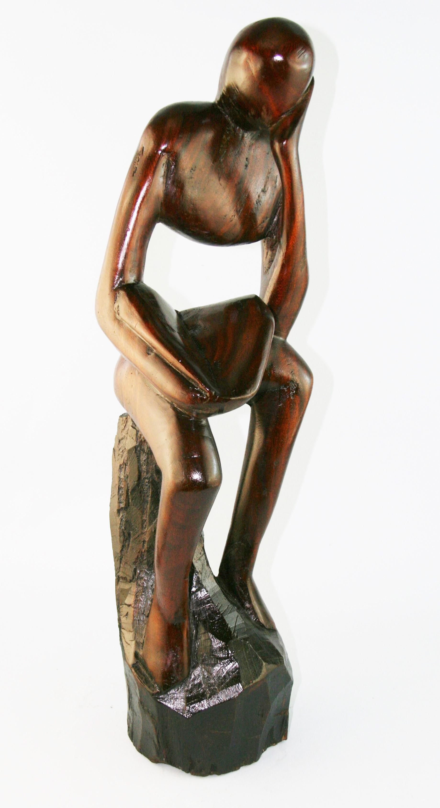 Hand carved wood abstract male seated figure.