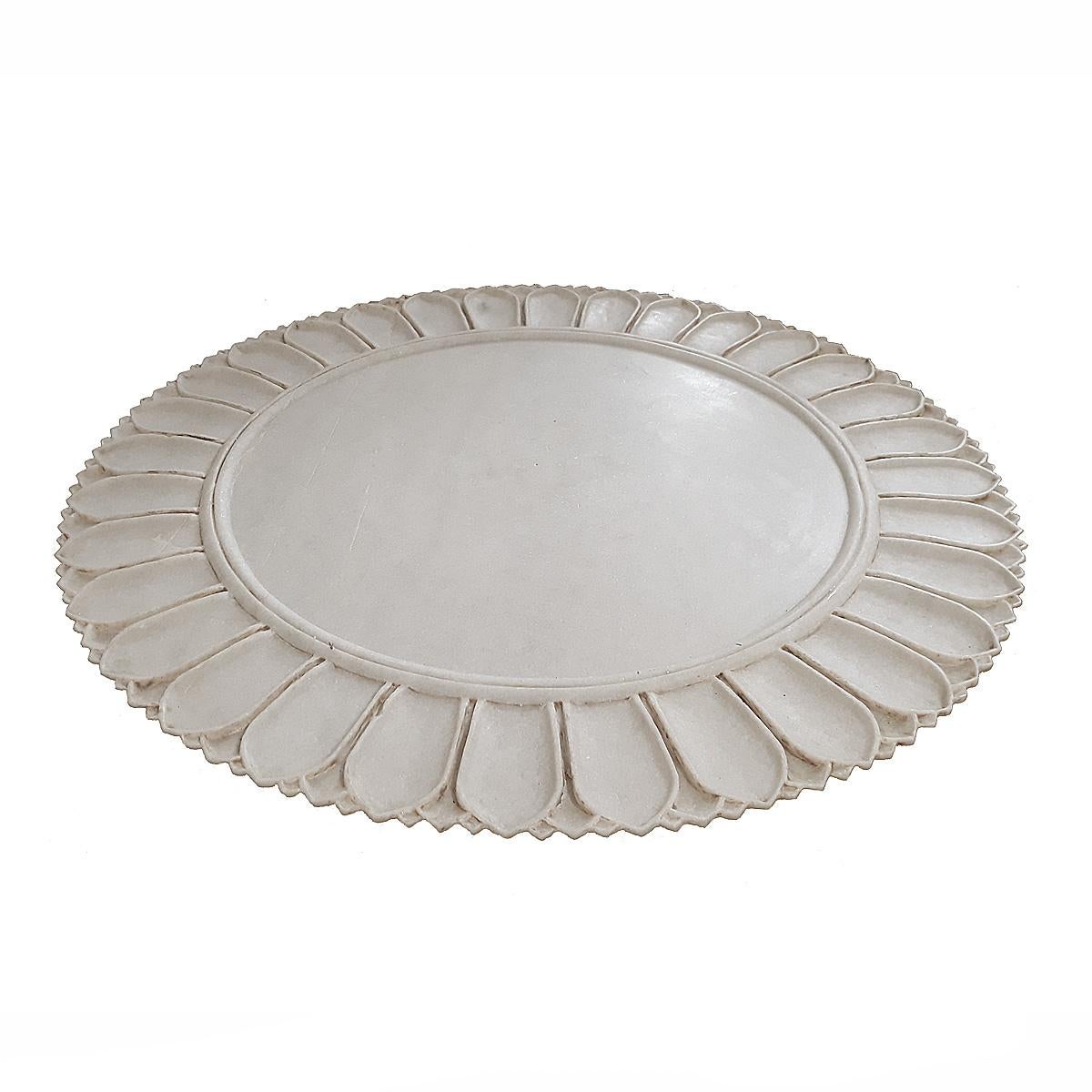 A hand-carved marble charger from India, circa 1980. 
Measures: 21 inches in diameter, half an inch high. 
Can be used as a charger, as a centerpiece or as a serving tray.