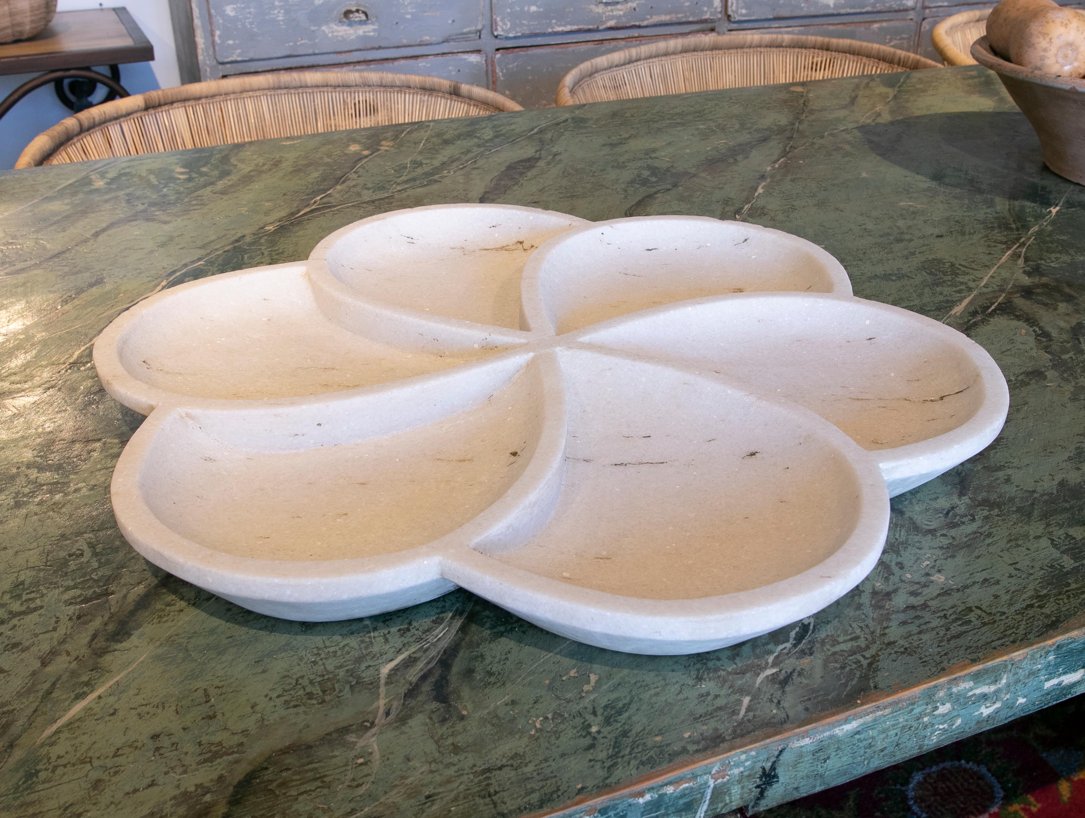 Hand-carved marble plate with rounded forms.