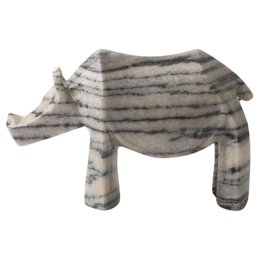The Hand Carved Marble Rhino Sculpture by Kunaal Kyhaan is part of a collection of sculptures that are inspired by Indian mythology and by exotic animals that are indigenous to India. 
Each animal is hand carved from a block of Marble and