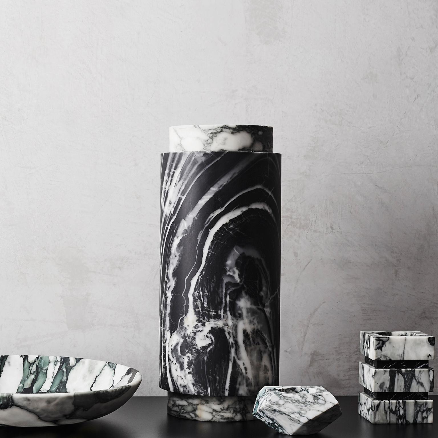 This stout, architectural design inspired by the work of Mario Botta, marries the playfulness of the Fiore marble and the drama of Nero Marble. Suited to use as a decorative ornament or pillar candle holder. 

Dimensions: L100mm/4