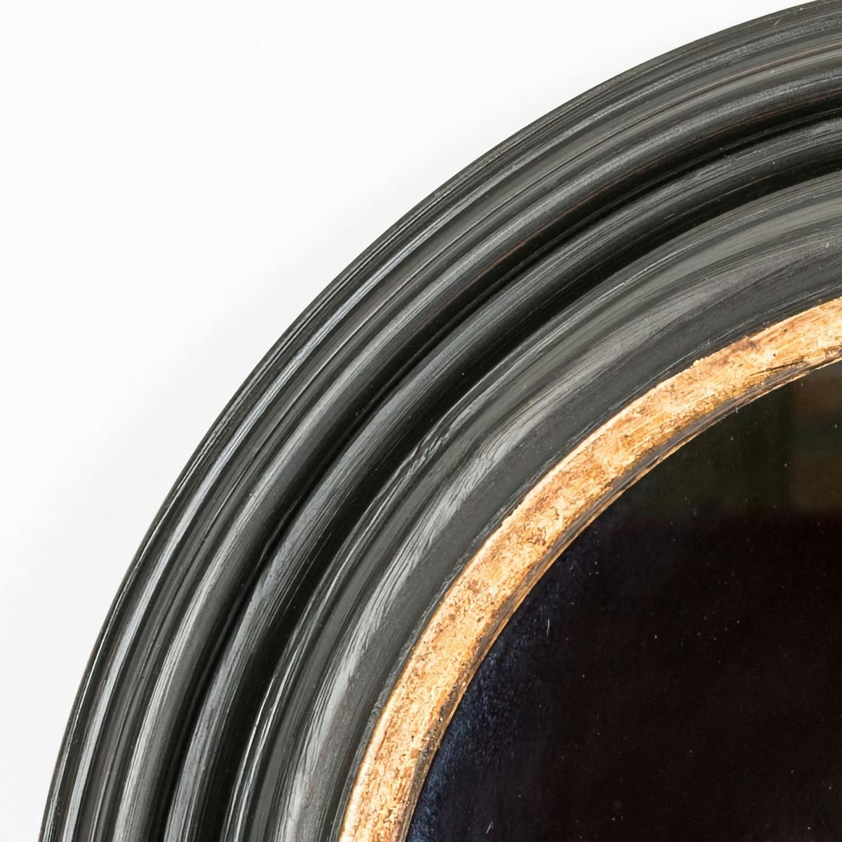 Hand carved wood and plaster, finished in a matte black and exquisite aged gilt painting technique, this mirror was created in Biarritz, France. Beautiful when hung on the wall, leaned on top of a piece of furniture or leaned on a mantel. These are