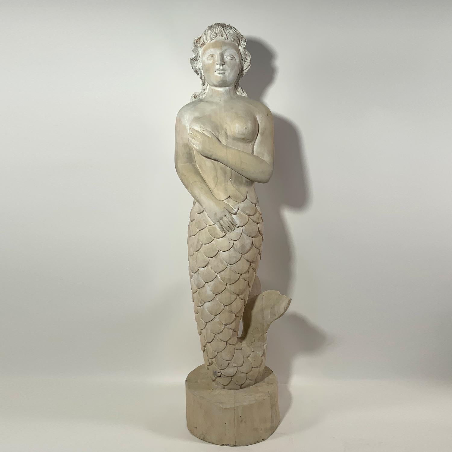 Well carved mermaid with upswept tail. Pretty face. Pickled white finish. Quality carving from a Nantucket Estate. Circa 1980.