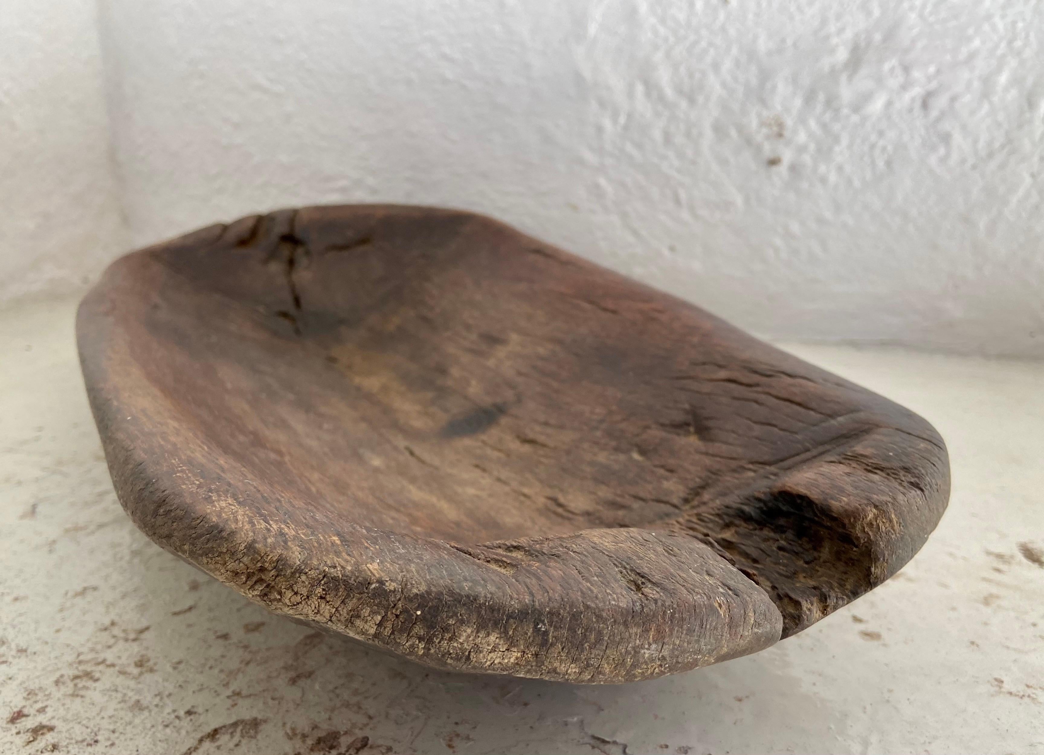 Hand carved hardwood tray from the Sierra Gorda region of Guanajuato, Mexico. This piece is significantly warn through time. Its weight is surprisingly heavy given the size of the piece. Beautiful texture and patina.