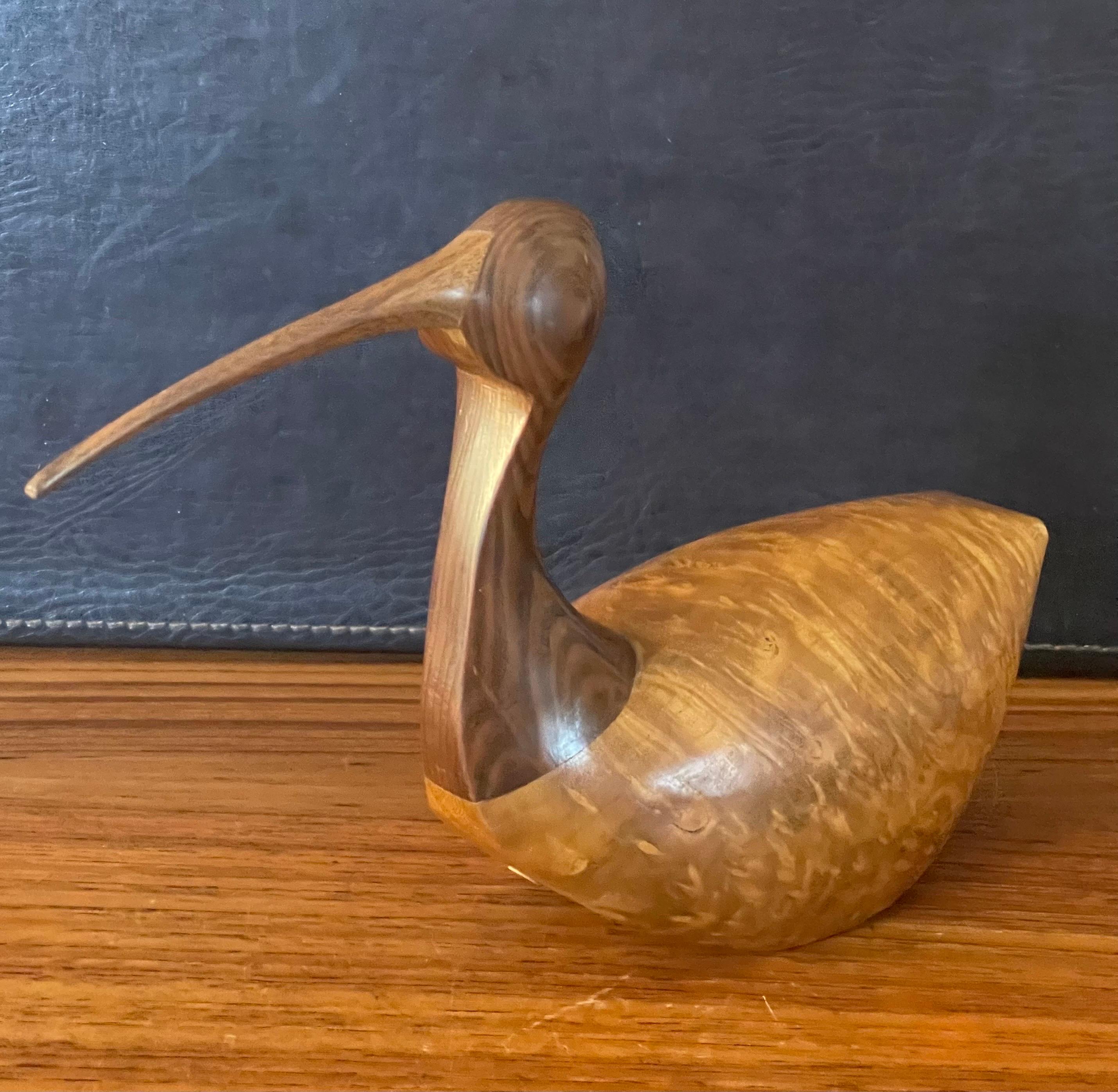 Fabulous hand carved mixed woods shore bird sculpture by Kevin Morin, circa 1990s. The piece is of exceptionally high quality and is made of myrtlewood, redwood and walnut; it is signed on the side. The sculpture is in very good vintage condition