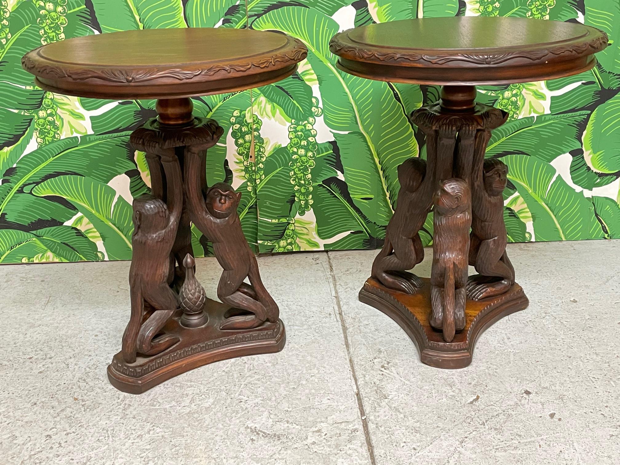 Pair of vintage side tables feature a fun motif of sculptural hand carved monkeys. Good vintage condition with minor imperfections consistent with age. One monkey's hand has a chip. 

 
 