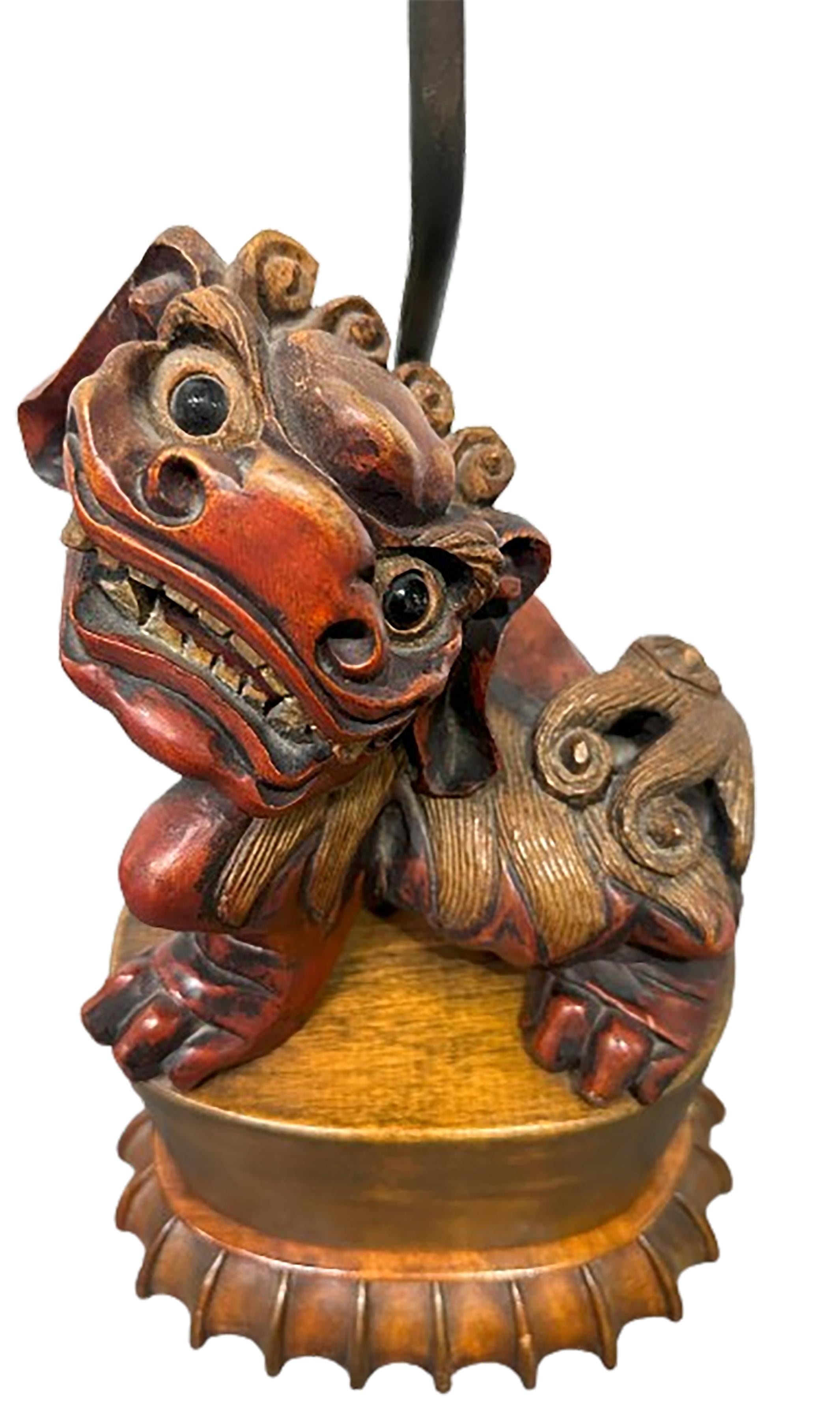 A charming vintage Asian hand carved foo lion figure lamp. Made with Nanmu wood, a super durable softwood unique to China and South Asia. Dual bulb inlet included. Lampshade not included. Hand carved and painted. The face of the figure is joyful and