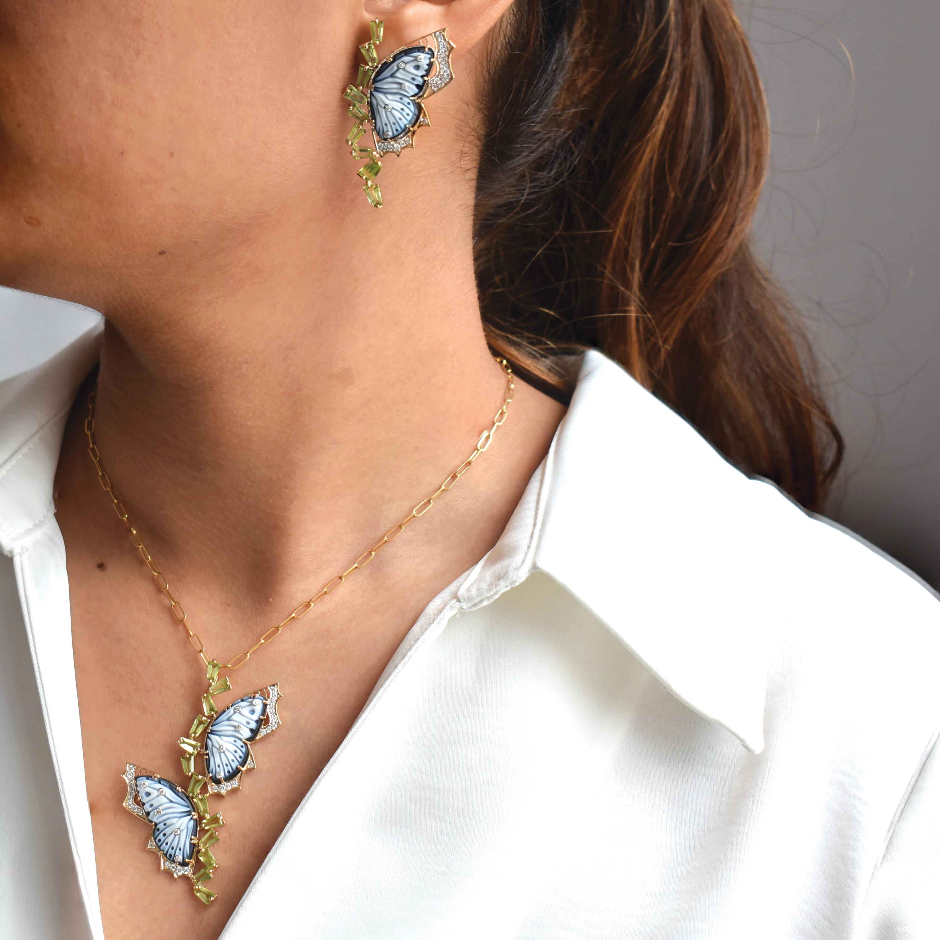 Cette extraordinaire parure comprend un pendentif et des boucles d'oreilles assorties, chacun mettant en valeur un papillon en agate naturelle méticuleusement sculpté à la main - un savant mélange d'artisanat sculptural et d'élégance de haute