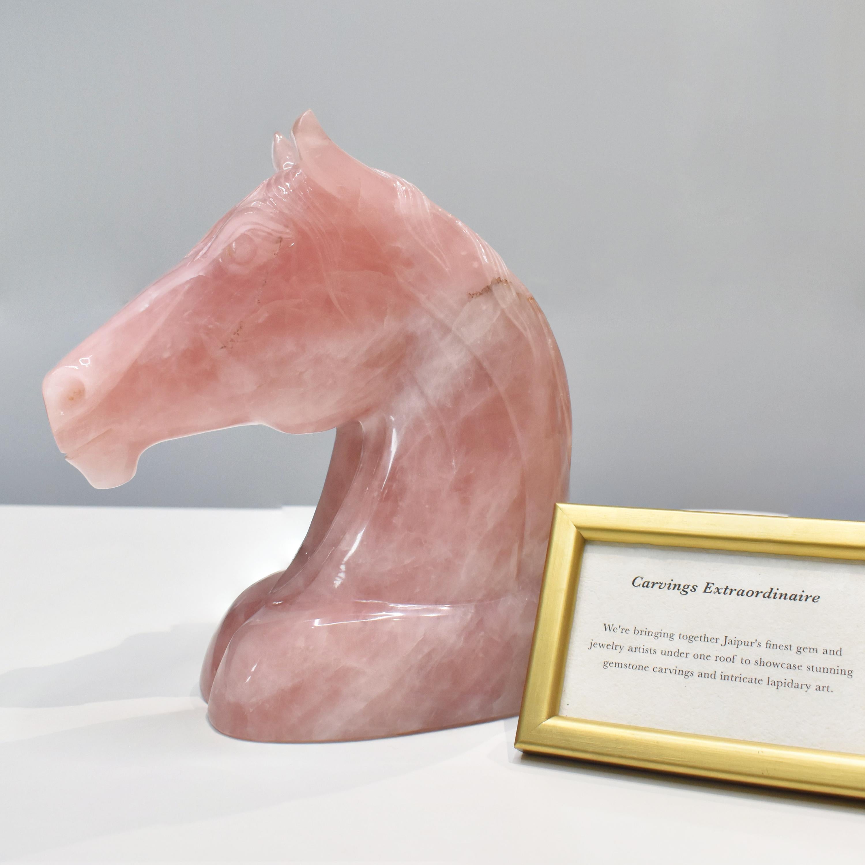 Embodying grace, strength, and serenity, this exquisite horse head sculpture is meticulously hand-carved from genuine rose quartz, a crystal celebrated for its soft pink hues and loving energy. Standing 22.6 cm tall and 17.1 cm wide, this finely