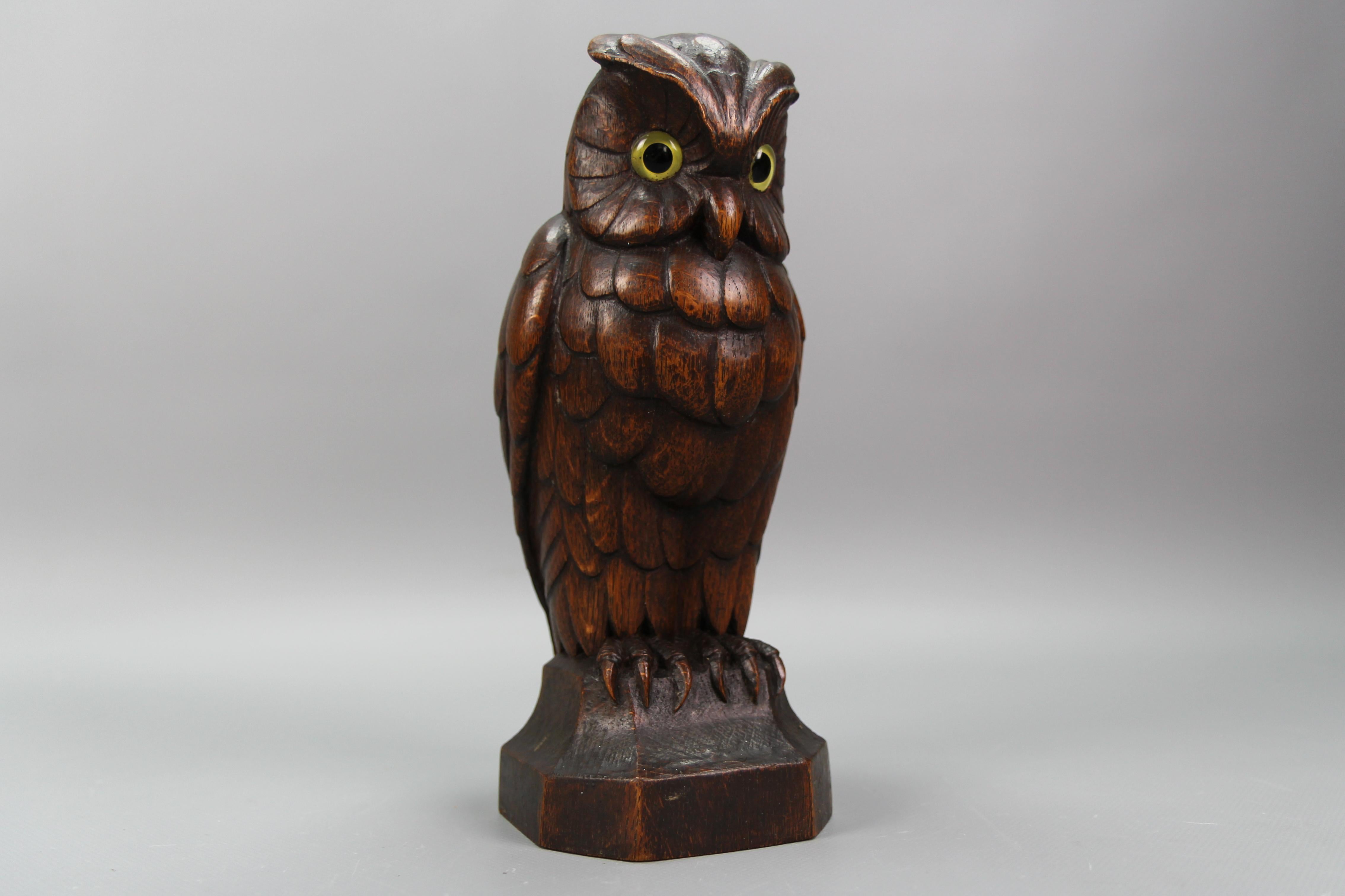 Art Deco style hand-carved oakwood owl sculpture, Germany, circa the 1930s.
This beautiful naturalistically carved dark brown wooden owl with glass eyes, sitting on a wooden base will be a great eye-catcher in any room or interior.
Dimensions: