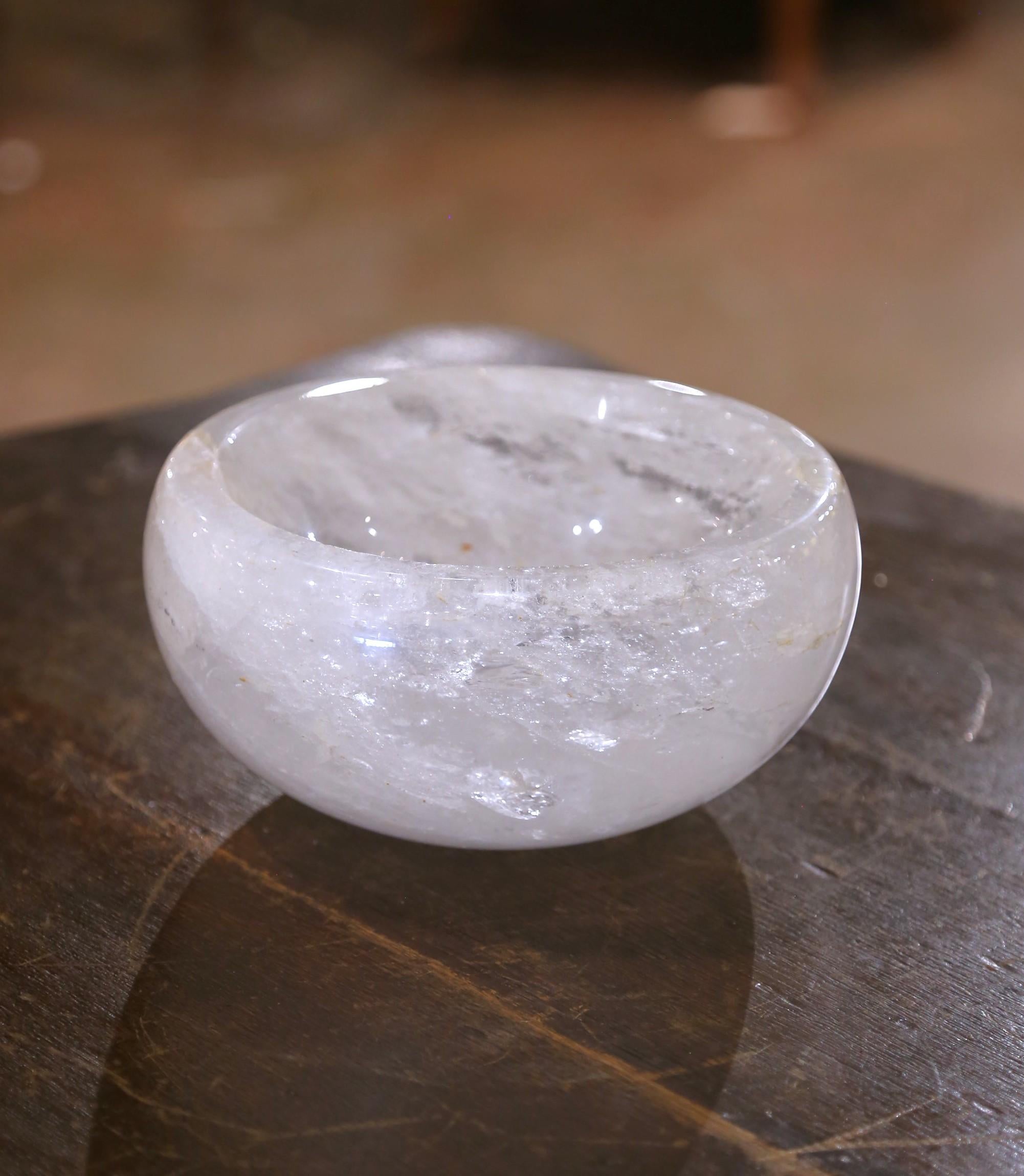 Place your keys or decorate an entry table or console with this luminous rock crystal bowl. Crafted in Brazil, the hand-carved dish features a rounded smooth form that highlights the natural clarity and veining of the quartz. The circular basin