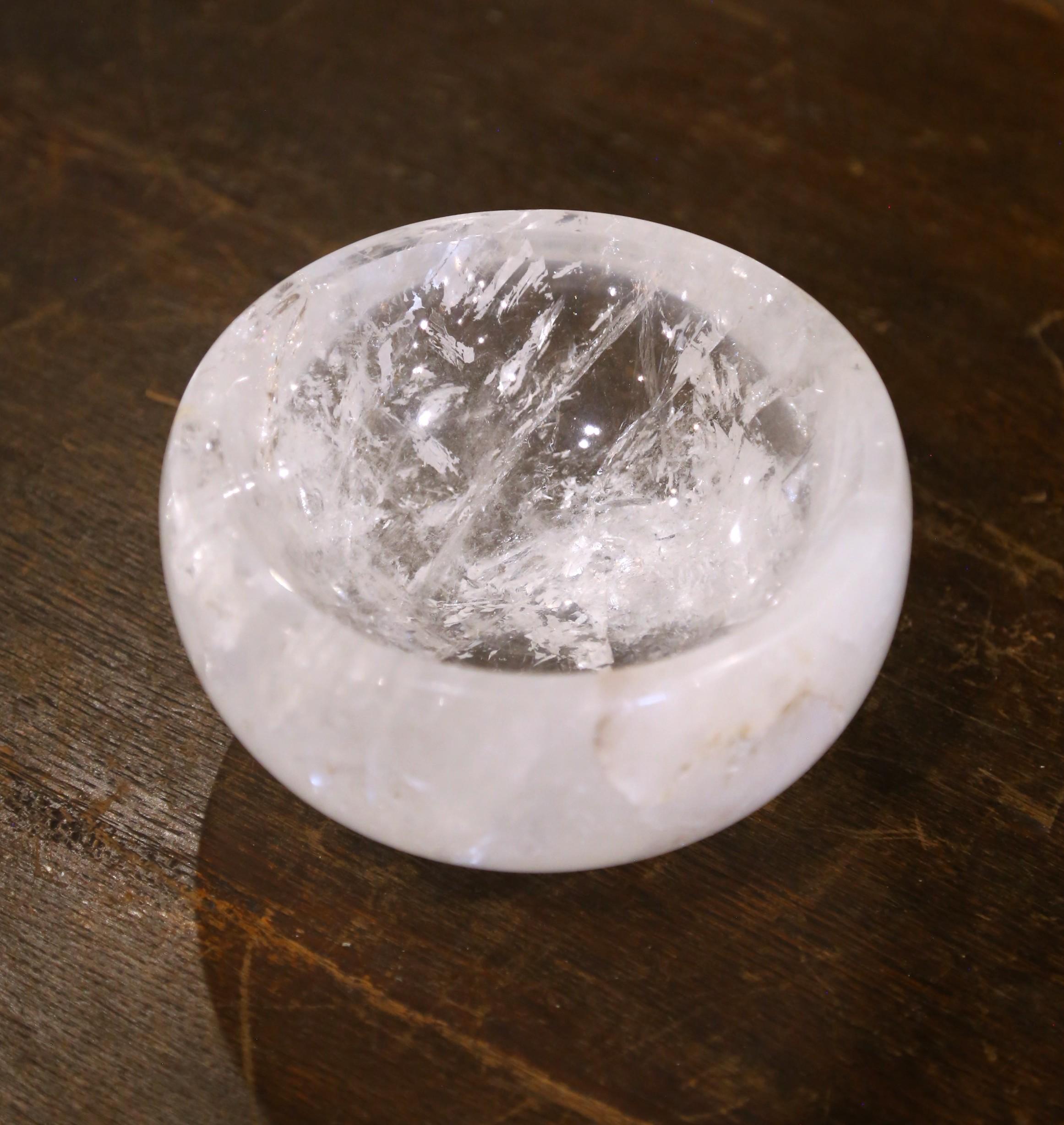 Place your keys or decorate an entry table or console with this luminous rock crystal bowl. Crafted in Brazil, the hand-carved dish features a rounded smooth form that highlights the natural clarity and veining of the quartz. The circular basin