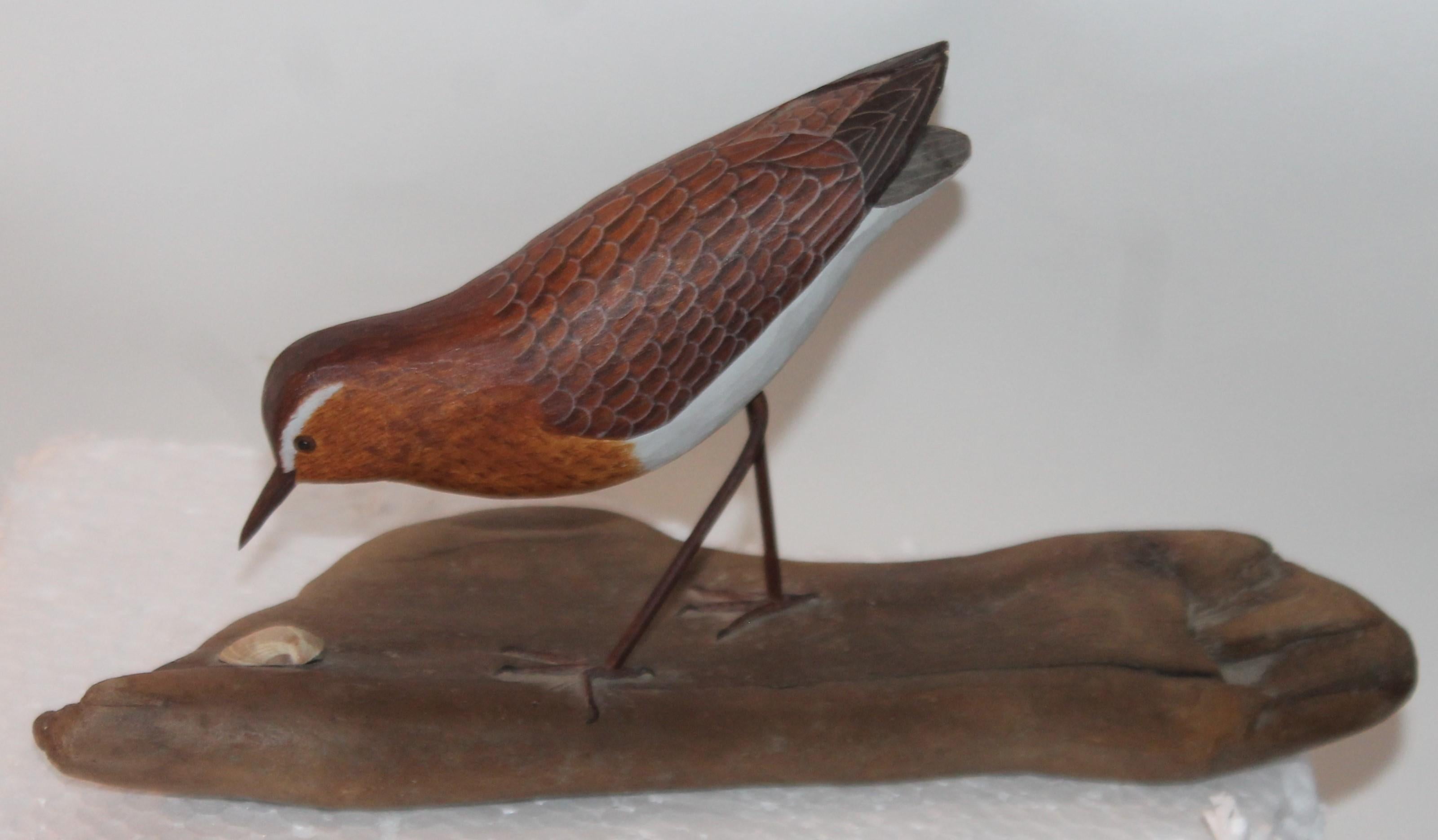 This finely paint decorated and hand carved shore bird is on a piece of drift wood. The condition is very good .This bird is very finely crafted.