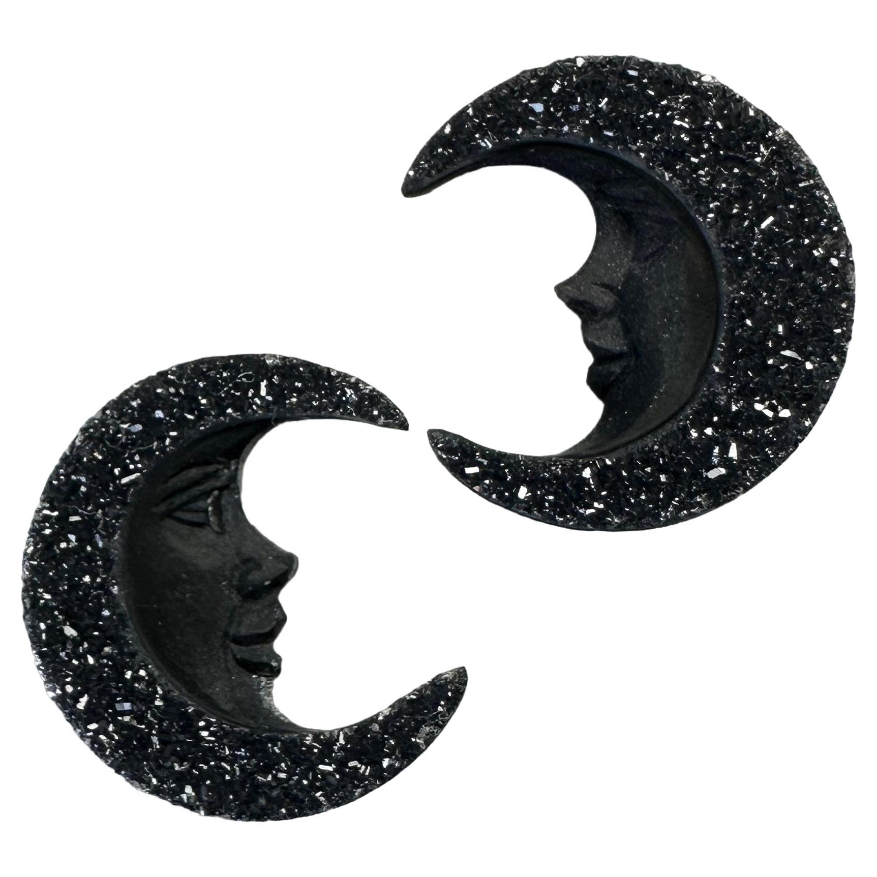 Hand carved pair of black druzy agate moon faces by Idar Oberstein masters. For Sale